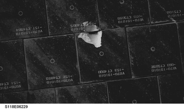 KENNEDY SPACE CENTER, FLA. -- This is a view taken by the astronauts during orbit of damaged tiles on the underside of Endeavour. The damage occurred from a piece of foam on the external tank during launch of Space Shuttle Endeavour on mission STS-118 on Aug. 8. After extensive engineering analysis of such images and testing on the ground, the Mission Management Team decided the tile did not pose a risk to the crew during re-entry. Endeavour landed safely at 12:32 p.m. EDT at NASA's Kennedy Space Center after a 13-day mission to the International Space Station. The STS-118 mission installed a new gyroscope, an external spare parts platform and another truss segment to the expanding station.