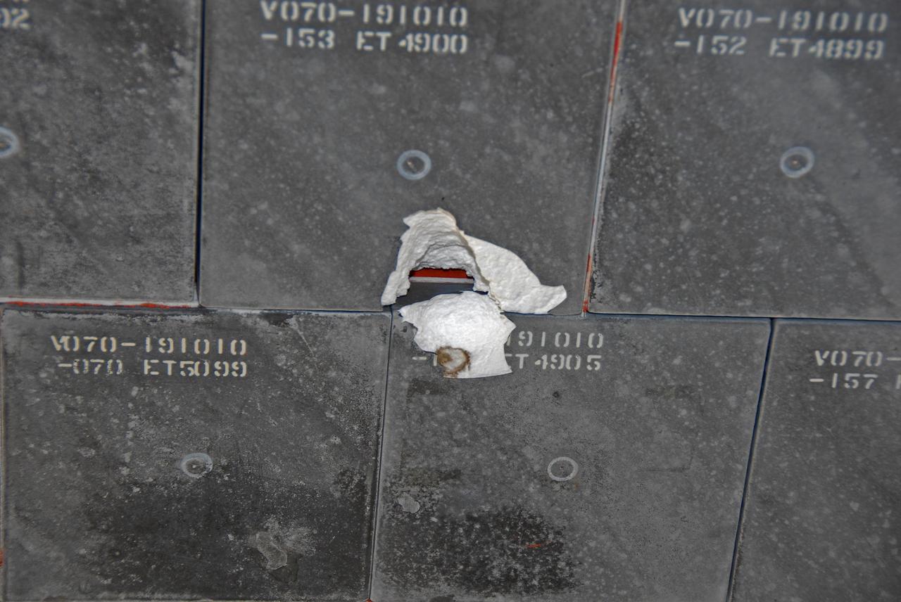 KENNEDY SPACE CENTER, FLA. --   This is a view of the underside of Endeavour taken after its landing on runway 15 at NASA's Kennedy Space Center.  The damage to the tiles occurred from a piece of foam on the external tank during launch of Space Shuttle Endeavour on mission STS-118 on Aug. 8.  After extensive engineering analysis of such images and testing on the ground, the Mission Management Team decided the tile did not pose a risk to the crew during re-entry.  Endeavour landed safely at 12:32 p.m. EDT at NASA's Kennedy Space Center after a 13-day mission to the International Space Station.  The STS-118 mission installed a new gyroscope, an external spare parts platform and another truss segment to the expanding station.  Photo credit: NASA/Kim Shiflett
