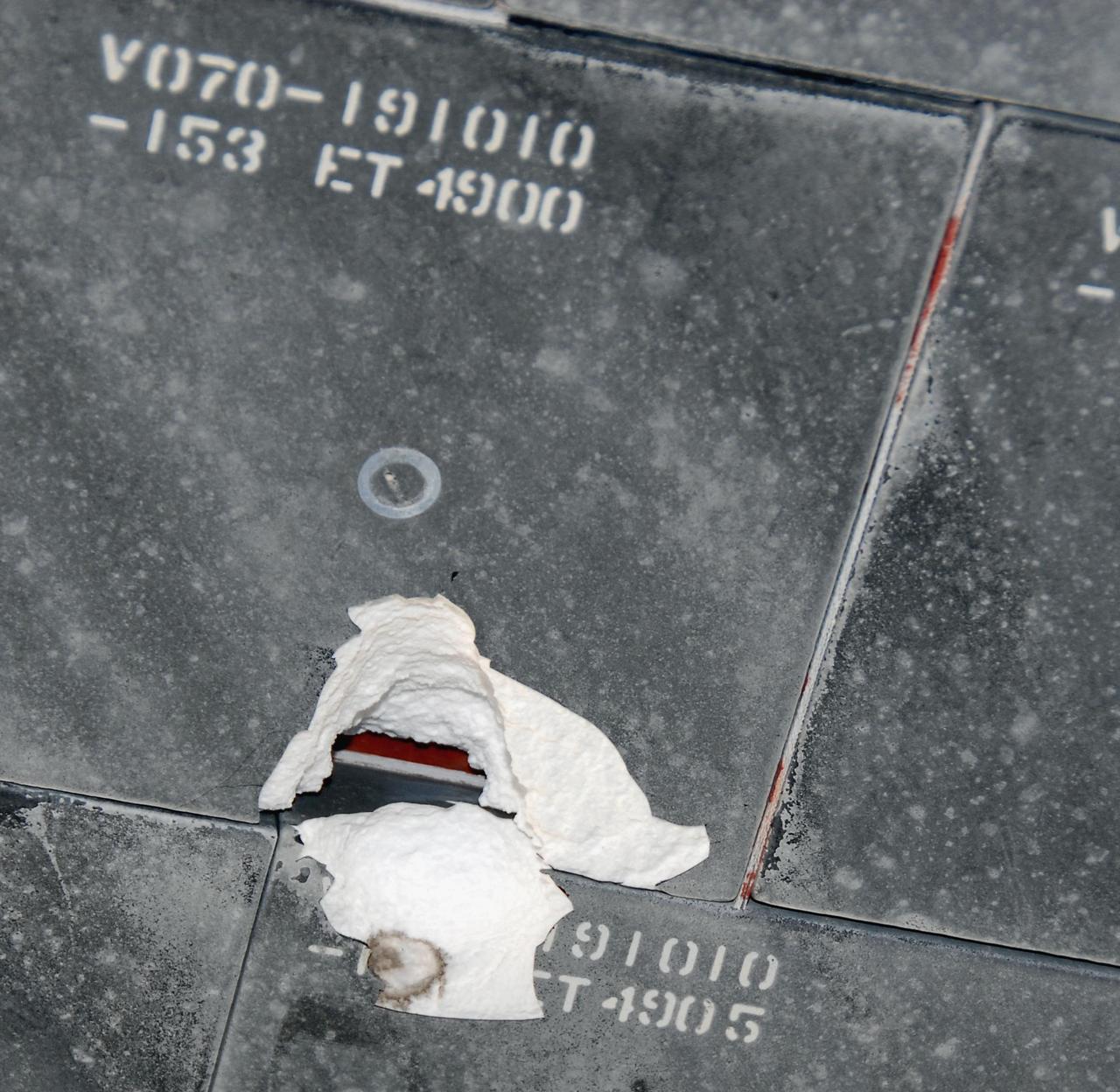 KENNEDY SPACE CENTER, FLA. --  This is a closer view of the underside of Endeavour taken after its landing on runway 15 at NASA's Kennedy Space Center.  The damage to the tiles occurred from a piece of foam on the external tank during launch of Space Shuttle Endeavour on mission STS-118 on Aug. 8.  After extensive engineering analysis of such images and testing on the ground, the Mission Management Team decided the tile did not pose a risk to the crew during re-entry.  Endeavour landed safely at 12:32 p.m. EDT at NASA's Kennedy Space Center after a 13-day mission to the International Space Station.  The STS-118 mission installed a new gyroscope, an external spare parts platform and another truss segment to the expanding station.   Photo credit: NASA/Kim Shiflett