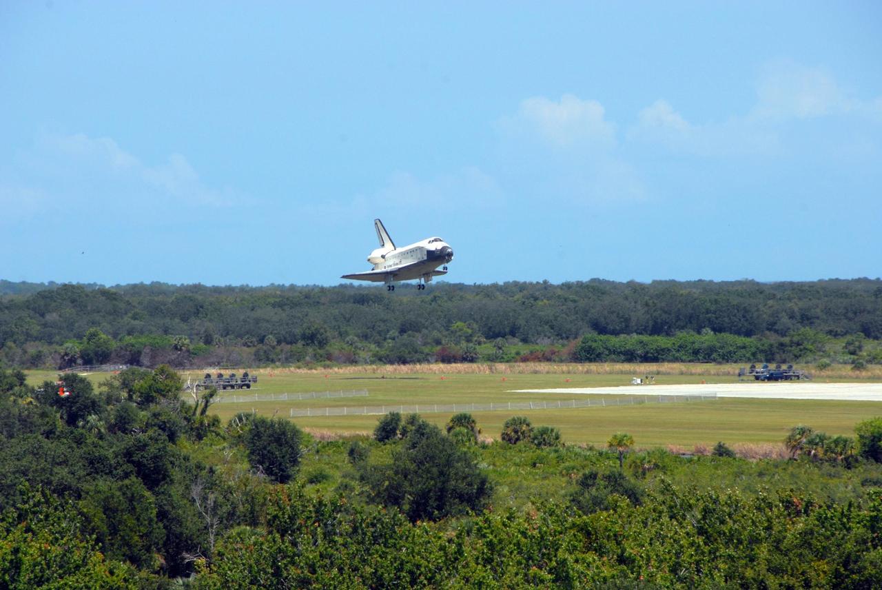 KENNEDY SPACE CENTER, FLA. -- Endeavour clears the trees as it approaches landing on runway 15 at NASA's Kennedy Space Center. The Space Shuttle Endeavour crew, led by Commander Scott Kelly, completes a 13-day mission to the International Space Station. The STS-118 mission began Aug. 8 and installed a new gyroscope, an external spare parts platform and another truss segment to the expanding station. Endeavour's main gear touched down at 12:32:16 p.m. EDT. Nose gear touchdown was at 12:32:29 p.m. and wheel stop was at 12:33:20 p.m. Endeavour traveled nearly 5.3 million miles, landing on orbit 201. STS-118 was the 119th space shuttle flight, the 22nd flight to the station, the 20th flight for Endeavour and the second of four missions planned for 2007. This was the 65th landing of an orbiter at Kennedy. Photo credit: NASA/Ken Thornsley