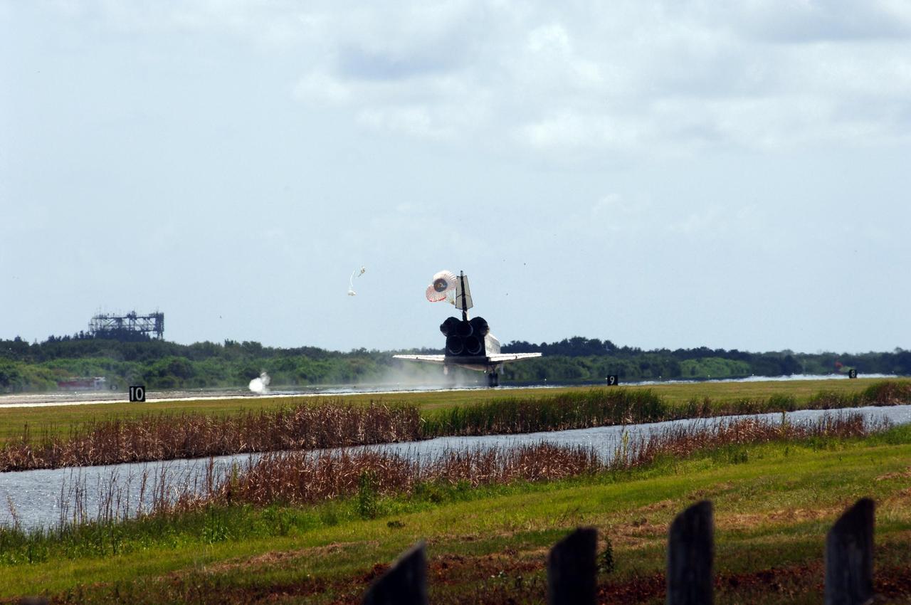 KENNEDY SPACE CENTER, FLA. --  Endeavour's drag chute opens to slow its landing on runway 15 at NASA's Kennedy Space Center after traveling nearly 5.3 million miles on mission STS-118.  The Space Shuttle Endeavour crew, led by Commander Scott Kelly, completes a 13-day mission to the International Space Station.  The STS-118 mission began Aug. 8 and installed a new gyroscope, an external spare parts platform and another truss segment to the expanding station.  Endeavour's main gear touched down at 12:32:16  p.m. EDT.  Nose gear touchdown was at 12:32:29 p.m. and wheel stop was at 12:33:20 p.m.  Endeavour landed on orbit 201. STS-118 was the 119th space shuttle flight, the 22nd flight to the station, the 20th flight for Endeavour and the second of four missions planned for 2007. This was the 65th landing of an orbiter at Kennedy.  Photo credit:  NASA/Rafael Hernandez