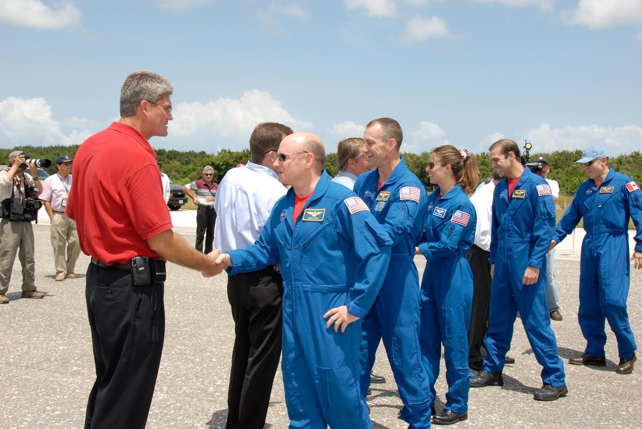 KENNEDY SPACE CENTER, FLA. --  The STS-118 crew is welcomed back to Earth by NASA officials after completing mission STS-118.  From left are KSC Director Bill Parsons, Mission Launch Integration Director Leroy Cain, Commander Scott Kelly, Shuttle Launch Director Mike Leinbach, Pilot Charlie Hobaugh, and Mission Specialists Tracy Caldwell, Rick Mastracchio and Canadian astronaut Dave Williams.  NASA Administrator Mike Griffin also greeted the astronauts.  On the mission, the crew installed a new gyroscope, an external spare parts platform and another truss segment to the expanding station.  Endeavour's main gear touched down at 12:32:16  p.m. EDT.  Nose gear touchdown was at 12:32:29 p.m. and wheel stop was at 12:33:20 p.m.  Endeavour landed on orbit 201. STS-118 was the 119th space shuttle flight, the 22nd flight to the station, the 20th flight for Endeavour and the second of four missions planned for 2007. This was the 65th landing of an orbiter at Kennedy.  Photo credit:  NASA/Kim Shiflett