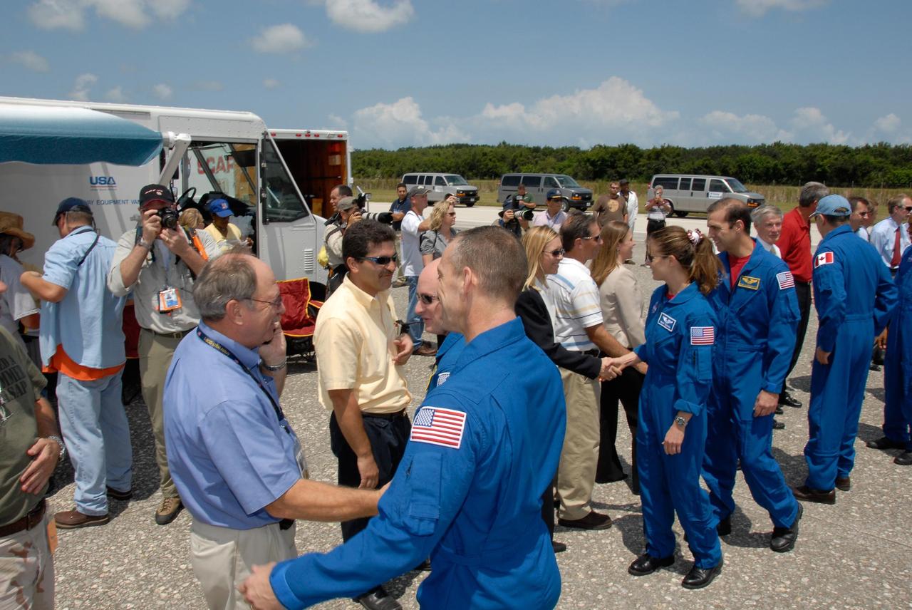 KENNEDY SPACE CENTER, FLA. --   The STS-118 crew is welcomed back to Earth by NASA officials after completing mission STS-118. The crew members are (from front) Pilot Charlie Hobaugh, Commander Scott Kelly, and Mission Specialists Tracy Caldwell, Rick Mastracchio and Canadian astronaut Dave Williams.  Williams is talking to Laurier Boisvert, president of the Canadian Space Agency. On the mission, the crew installed a new gyroscope, an external spare parts platform and another truss segment to the expanding station.  Endeavour's main gear touched down at 12:32:16  p.m. EDT.  Nose gear touchdown was at 12:32:29 p.m. and wheel stop was at 12:33:20 p.m.  Endeavour landed on orbit 201. STS-118 was the 119th space shuttle flight, the 22nd flight to the station, the 20th flight for Endeavour and the second of four missions planned for 2007. This was the 65th landing of an orbiter at Kennedy.  Photo credit:  NASA/Kim Shiflett