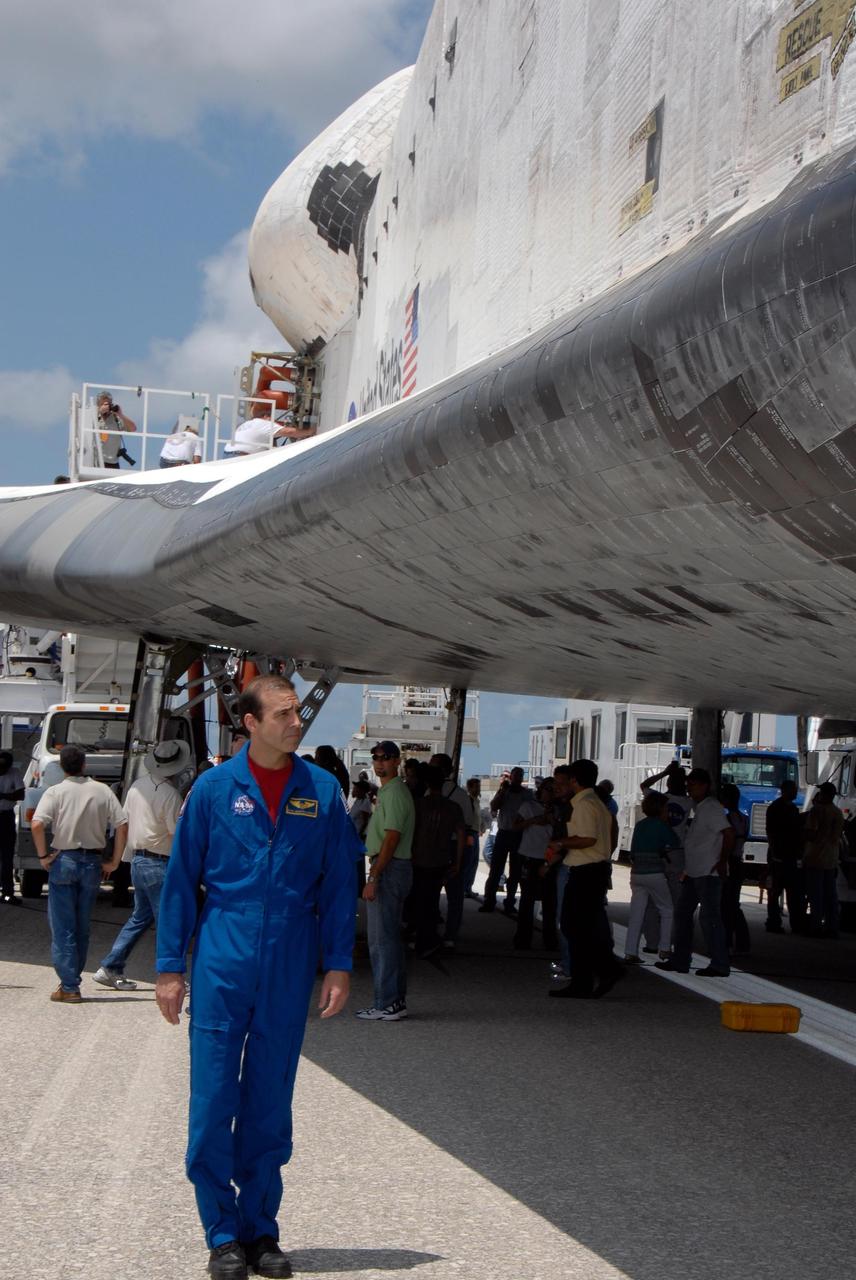 KENNEDY SPACE CENTER, FLA. --  STS-118 Mission Specialist walks under the wing of Endeavour to check out the tile damage.  He and the rest of the crew have just returned from a 13-day mission to the International Space Station. On the mission, the crew installed a new gyroscope, an external spare parts platform and another truss segment to the expanding station.  Endeavour's main gear touched down at 12:32:16  p.m. EDT.  Nose gear touchdown was at 12:32:29 p.m. and wheel stop was at 12:33:20 p.m.  Endeavour landed on orbit 201. STS-118 was the 119th space shuttle flight, the 22nd flight to the station, the 20th flight for Endeavour and the second of four missions planned for 2007. This was the 65th landing of an orbiter at Kennedy.  Photo credit:  NASA/Kim Shiflett