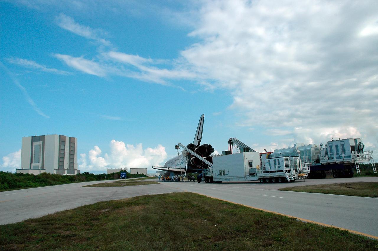 KENNEDY SPACE CENTER, FLA. --   On the Shuttle Landing Facility at NASA's Kennedy Space Center, the orbiter Endeavour is ready to be towed to the Orbiter Processing Facility, known as the OPF.  At far left is the towering Vehicle Assembly Building.  Next to it, just on the horizon, are the OPF hangars.  Endeavour returned to Earth Aug. 21 from mission STS-118, landing at Kennedy at 12:32 p.m. EDT. In the OPF bay 2, Endeavour will incur thermal protection system inspections and numerous other post-flight inspections before processing starts for its next voyage into space.  Endeavour will next fly on mission STS-123 targeted for Feb. 14, 2008.  Photo credit: NASA/Jack Pfaller