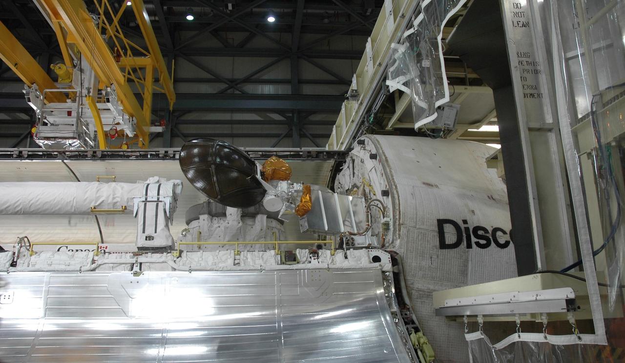 KENNEDY SPACE CENTER, FLA. -- In the Orbiter Processing Facility, the Ku-band communications antenna is stowed in the payload bay of Discovery before the bay's doors are closed. The stowage is in preparation for the rollover of the orbiter to the Vehicle Assembly Building. The primary payload, the U.S. Node 2, which is named Harmony, will be installed in the payload bay at the pad prior to Discovery's liftoff on mission STS-120. The mission will be the 23rd flight for the assembly of the International Space Station. Space Shuttle Discovery is targeted for launch on Oct. 23. Photo credit: NASA/Jim Grossmann