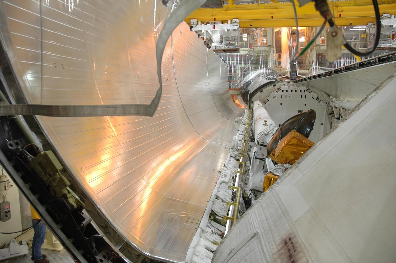 KENNEDY SPACE CENTER, FLA. -- In the Orbiter Processing Facility, the payload bay doors of Discovery are being closed in preparation for the rollover of the orbiter to the Vehicle Assembly Building. The primary payload, the U.S. Node 2, which is named Harmony, will be installed in the payload bay at the pad prior to Discovery's liftoff on mission STS-120. The mission will be the 23rd flight for the assembly of the International Space Station. Space Shuttle Discovery is targeted for launch on Oct. 23. Photo credit: NASA/Jim Grossmann
