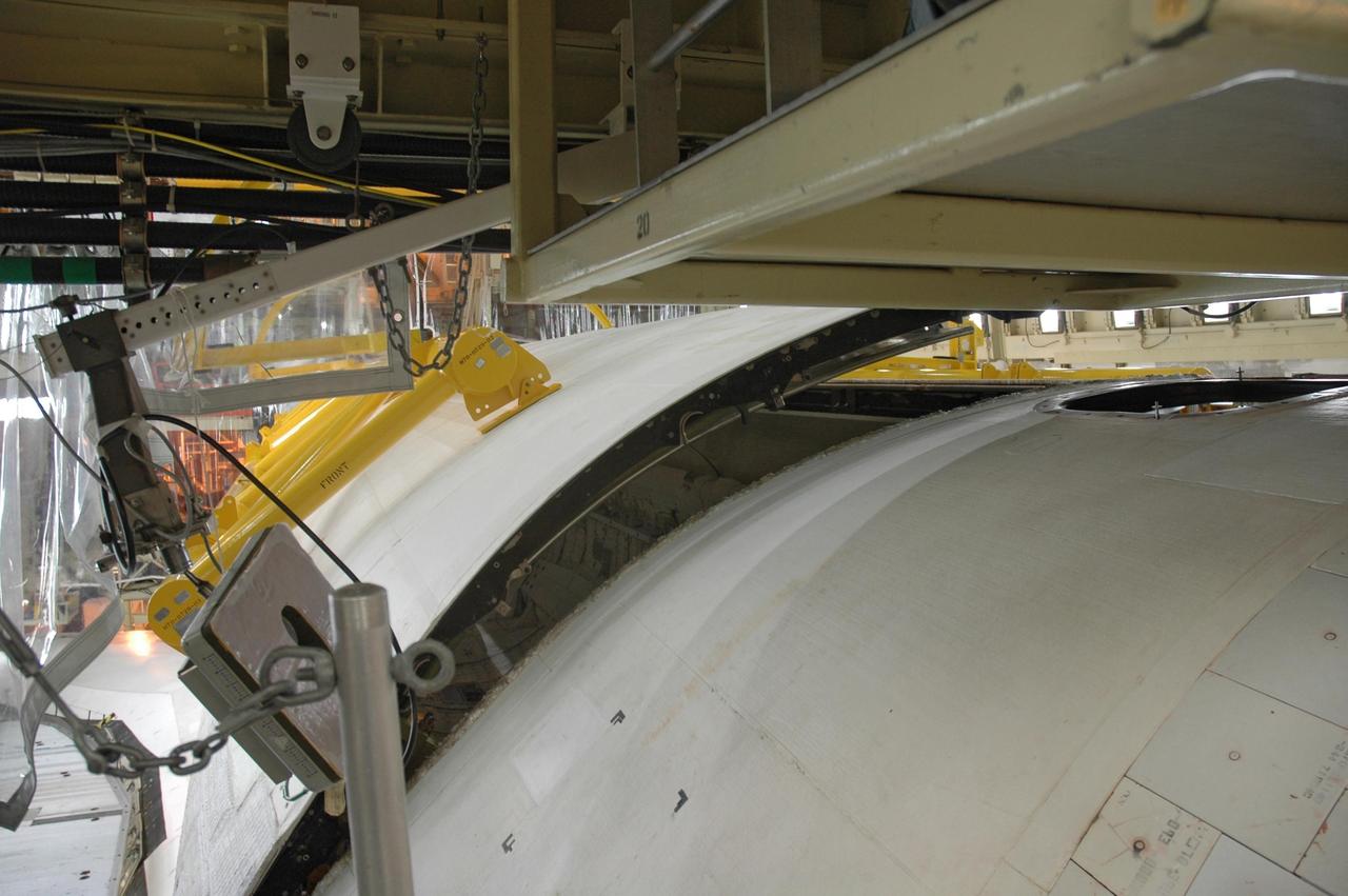 KENNEDY SPACE CENTER, FLA. -- In the Orbiter Processing Facility, the right payload bay door of Discovery is nearly closed in preparation for the rollover of the orbiter to the Vehicle Assembly Building. The primary payload, the U.S. Node 2, which is named Harmony, will be installed in the payload bay at the pad prior to Discovery's liftoff on mission STS-120. The mission will be the 23rd flight for the assembly of the International Space Station. Space Shuttle Discovery is targeted for launch on Oct. 23. Photo credit: NASA/Jim Grossmann