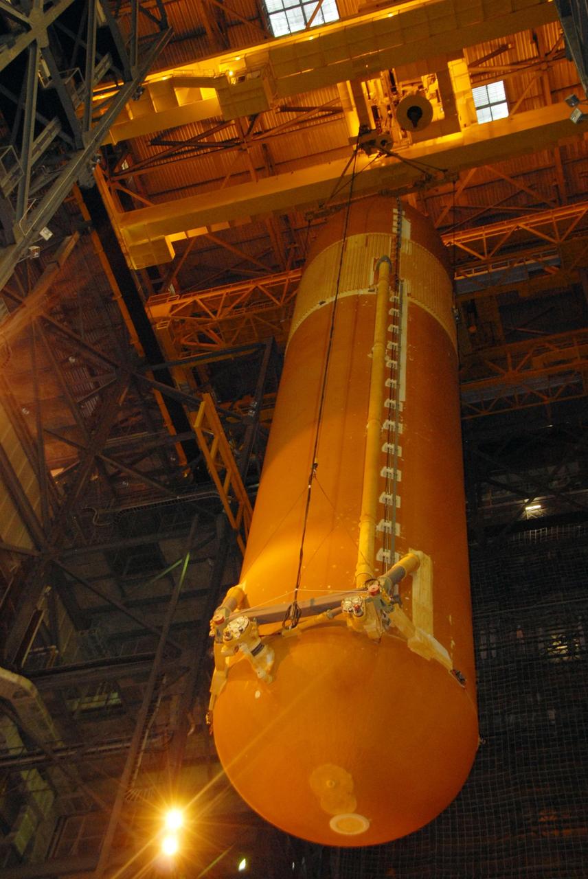 KENNEDY SPACE CENTER, FLA. --    In the Vehicle Assembly Building at NASA's Kennedy Space Center, external tank No. 120 is lowered into high bay 1 where it will be mated with the solid rocket boosters. Seen on the tank are the sites of modification to the foam where BX265 foam insulation and super lightweight ablator, cork insulation was removed and the BX265 foam insulation alone reapplied. The external tank-SRB stack is being prepared for the orbiter Discovery, which will be mated to the stack in the VAB in two weeks.  Space Shuttle Discovery is targeted to launch Oct. 23 on mission STS-120 to the International Space Station.  Photo credit: NASA/George Shelton