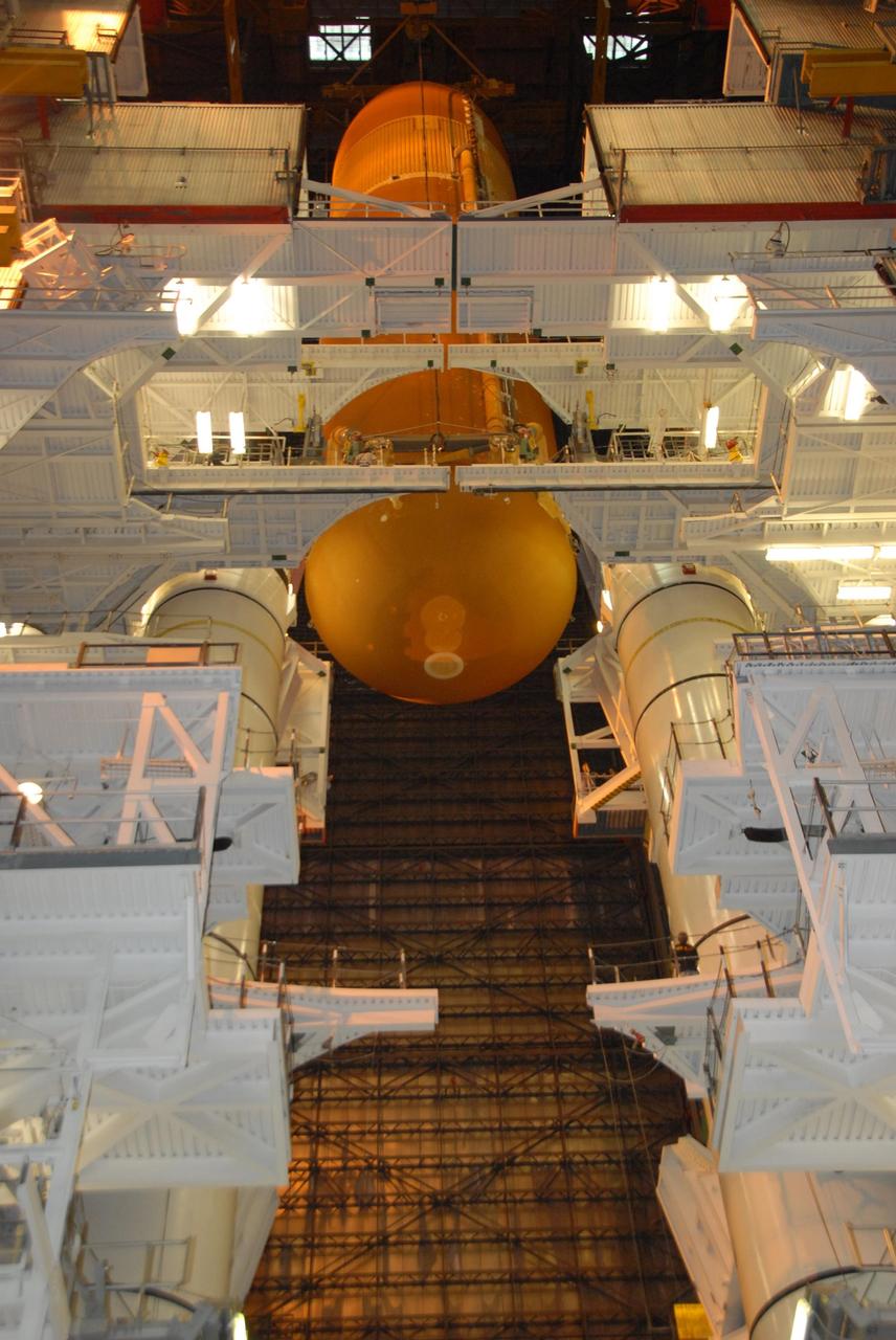 KENNEDY SPACE CENTER, FLA. --    In the Vehicle Assembly Building at NASA's Kennedy Space Center, external tank No. 120 is lowered toward the mobile launcher platform in high bay 1 where it will be mated with the solid rocket boosters already there. The external tank-SRB stack is being prepared for the orbiter Discovery, which will be mated to the stack in the VAB in two weeks.  Space Shuttle Discovery is targeted to launch Oct. 23 on mission STS-120 to the International Space Station.  Photo credit: NASA/George Shelton