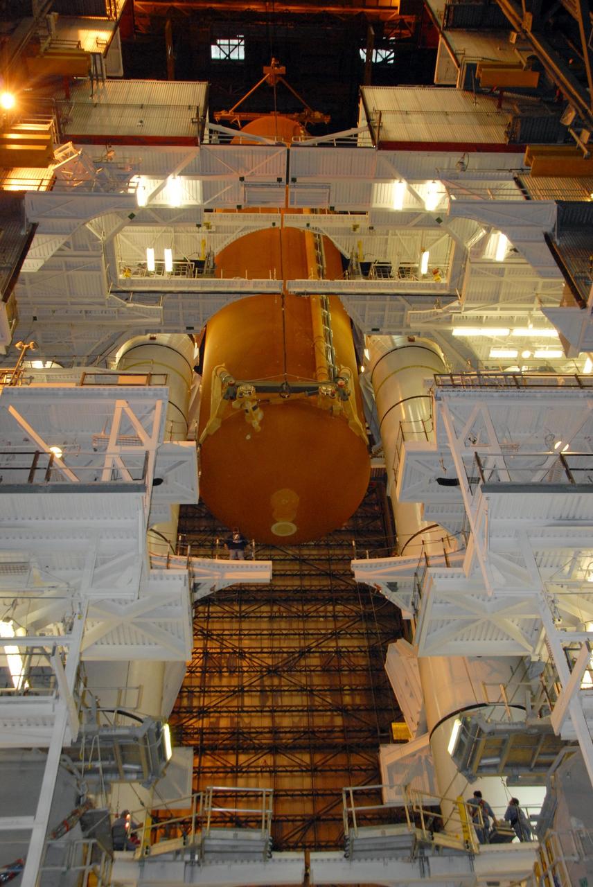 KENNEDY SPACE CENTER, FLA. --   In the Vehicle Assembly Building at NASA's Kennedy Space Center, external tank No. 120 is lowered between the solid rocket boosters for mating on the mobile launcher platform. The external tank-SRB stack is being prepared for the orbiter Discovery, which will be mated to the stack in the VAB in two weeks.  Space Shuttle Discovery is targeted to launch Oct. 23 on mission STS-120 to the International Space Station.  Photo credit: NASA/George Shelton