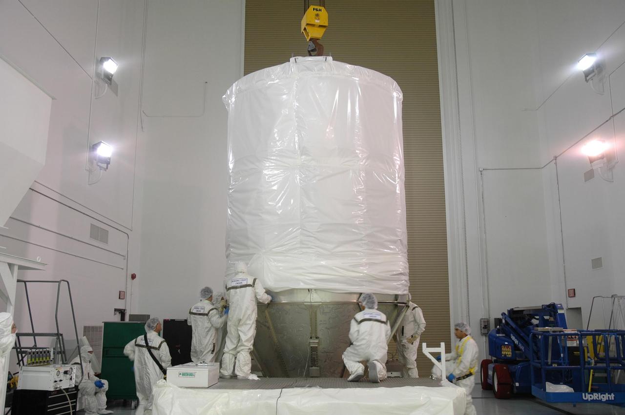 KENNEDY SPACE CENTER, FLA. -- At Astrotech Space Operations in Titusville, Fla., workers ensure the upper transportation canister is securely attached to the lower segments.  The transportation canister will protect the spacecraft and booster during transfer to Launch Pad 17-B at Cape Canaveral Air Force Station (CCAFS). During its nearly decade-long mission, the Dawn mission will study the asteroid Vesta and dwarf planet Ceres, celestial bodies believed to have accreted early in the history of the solar system. To carry out its scientific mission, the Dawn spacecraft will carry a visible camera, a visible and infrared mapping spectrometer, and a gamma ray and neutron spectrometer, whose data will be used in combination to characterize these bodies.  In addition to the three instruments, radiometric and optical navigation data will provide data relating to the gravity field and thus bulk properties and internal structure of the two bodies. Data returned from the Dawn spacecraft could provide opportunities for significant breakthroughs in our knowledge of how the solar system formed. Launch via a Delta II rocket is scheduled in a window from 7:25 to 7:54 a.m. Sept. 26 from CCAFS.  Photo credit: NASA/Jim Grossmann