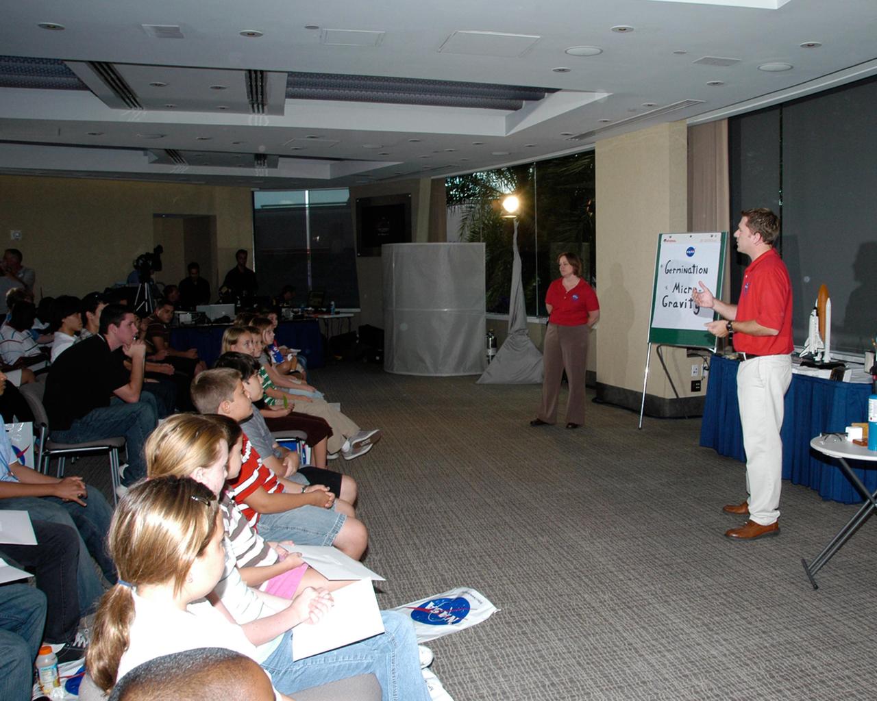 KENNEDY SPACE CENTER, FLA. -- NASA's Kennedy Space Center Education Specialists Linda Scauzillo and Christopher Blair take part in a special education session with local students at Epcot's Base21 Siemens VIP Center.  The event was part of the day's activities honoring the space shuttle Endeavour crew of mission STS-118.  The crew met with the media and paraded down Main Street.  The event also honored teacher-turned-astronaut Barbara R. Morgan, who dedicated a plaque outside the Mission: Space attraction.  The other crew members attending were Commander Scott Kelly, Pilot Charlie Hobaugh and Mission Specialists Tracy Caldwell, Dave Williams, Rick Mastracchio and Alvin Drew.  Mission STS-118 was the 119th shuttle program flight and the 22nd flight to the International Space Station.  Space shuttle Endeavour launched from NASA's Kennedy Space Center on Aug. 8 and landed Aug. 21.  The mission delivered the S5 truss, continuing the assembly of the space station.  Photo credit: NASA/George Shelton