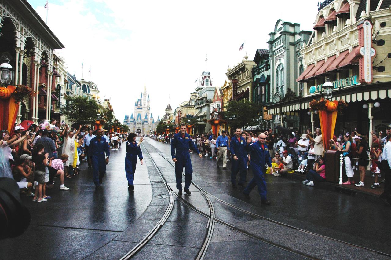KENNEDY SPACE CENTER, FLA. -- Members of the space shuttle mission STS-118 crew march down Main Street at Walt Disney World in Orlando.  From left are Mission Specialists Alvin Drew, Barbara R. Morgan and Dave Williams, Pilot Charlie Hobaugh, Mission Specialist Tracy Caldwell and Commander Scott Kelly.  Not pictured but present is Mission Specialist Rick Mastracchio.  The event also honored teacher-turned-astronaut Morgan, who dedicated a plaque outside the Mission: Space attraction.   Other activities included meeting with the media and students.  Mission STS-118 was the 119th shuttle program flight and the 22nd flight to the International Space Station.  Space shuttle Endeavour launched from NASA's Kennedy Space Center on Aug. 8 and landed Aug. 21.  The mission delivered the S5 truss, continuing the assembly of the space station.  Photo credit: NASA/George Shelton