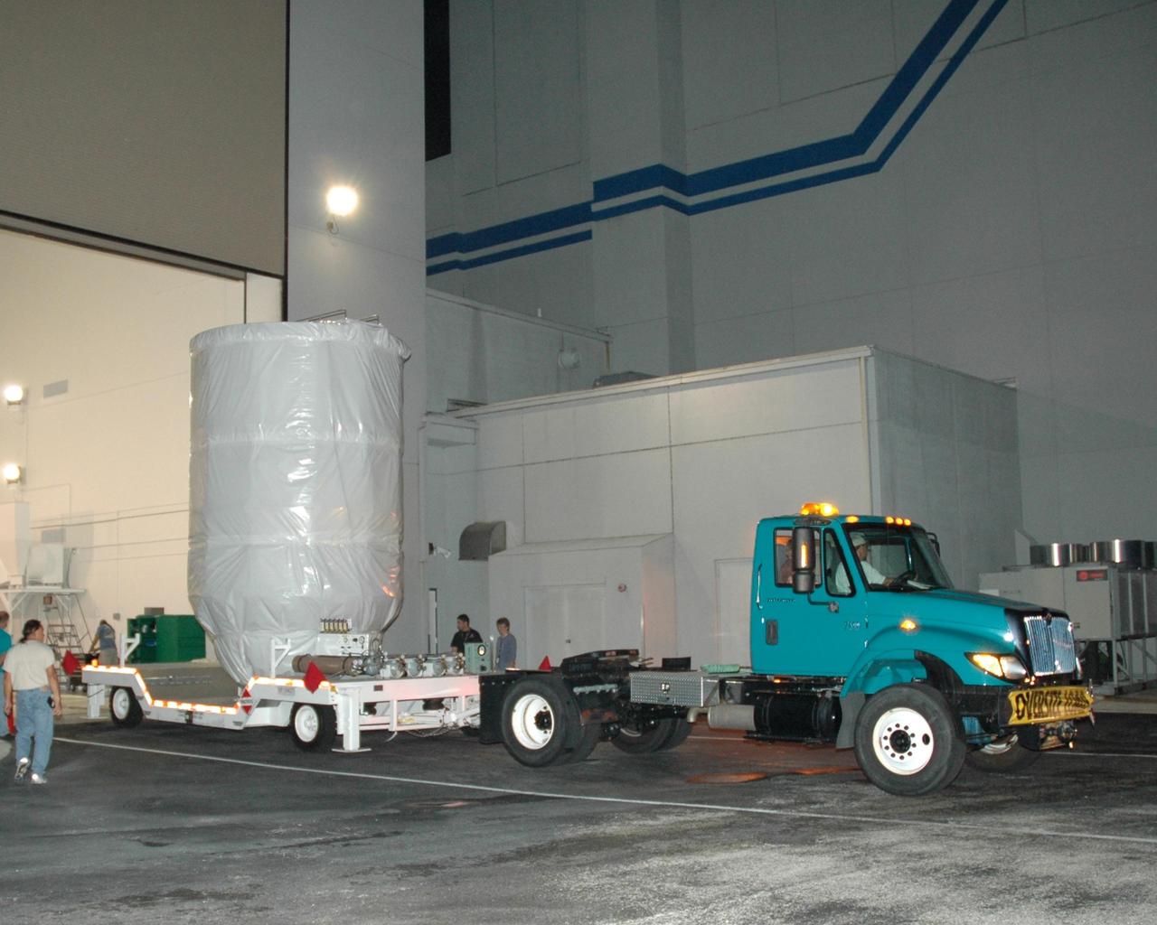 KENNEDY SPACE CENTER, FLA. -- The Dawn spacecraft is moved out of the Astrotech Space Operations facility, on its way to Launch Pad 17-B at Cape Canaveral Air Force Station.  At the pad, Dawn will be lifted into the mobile service tower and prepared for mating with the awaiting Delta II rocket.  Dawn is scheduled for launch in a window from 7:25 to 7:54 a.m. Sept. 26 from CCAFS.  During its nearly decade-long mission, the Dawn mission will study the asteroid Vesta and dwarf planet Ceres, celestial bodies believed to have accreted early in the history of the solar system. To carry out its scientific mission, the Dawn spacecraft will carry a visible camera, a visible and infrared mapping spectrometer, and a gamma ray and neutron spectrometer, whose data will be used in combination to characterize these bodies.  In addition to the three instruments, radiometric and optical navigation data will provide data relating to the gravity field and thus bulk properties and internal structure of the two bodies. Data returned from the Dawn spacecraft could provide opportunities for significant breakthroughs in our knowledge of how the solar system formed. Photo credit: NASA/Jack Pfaller