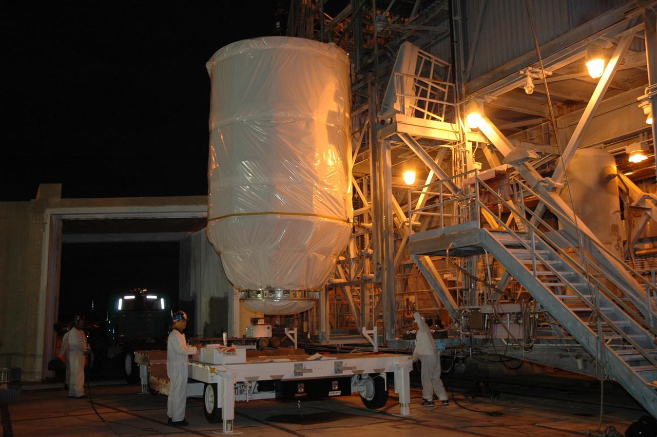 KENNEDY SPACE CENTER, FLA. --  On Launch Pad 17-B at Cape Canaveral Air Force Station, the Dawn spacecraft is lifted off its transporter.  Dawn will be lifted into the mobile service tower and prepared for mating with the awaiting Delta II rocket.Dawn is scheduled for launch in a window from 7:25 to 7:54 a.m. Sept. 26 from CCAFS.  During its nearly decade-long mission, the Dawn mission will study the asteroid Vesta and dwarf planet Ceres, celestial bodies believed to have accreted early in the history of the solar system. To carry out its scientific mission, the Dawn spacecraft will carry a visible camera, a visible and infrared mapping spectrometer, and a gamma ray and neutron spectrometer, whose data will be used in combination to characterize these bodies.  In addition to the three instruments, radiometric and optical navigation data will provide data relating to the gravity field and thus bulk properties and internal structure of the two bodies. Data returned from the Dawn spacecraft could provide opportunities for significant breakthroughs in our knowledge of how the solar system formed. Photo credit: NASA/Jack Pfaller