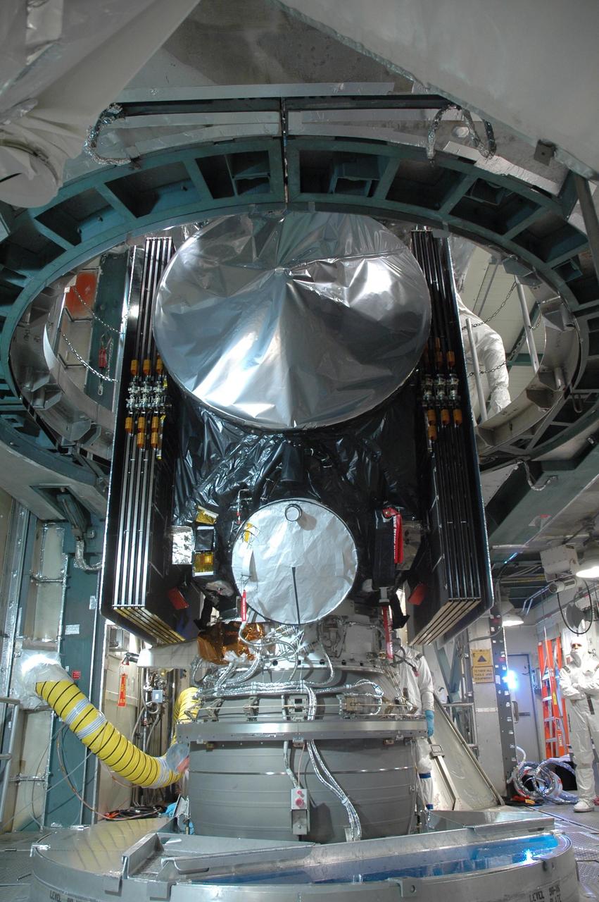 KENNEDY SPACE CENTER, FLA. --   In the mobile service tower on Launch Pad 17-B at Cape Canaveral Air Force Station, the upper transportation canister is lifted away from the Dawn spacecraft.  After removal of the canister, Dawn will be mated with the waiting Delta II rocket.  Dawn is scheduled for launch in a window from 7:25 to 7:54 a.m. EDT Sept. 26 from CCAFS.  During its nearly decade-long mission, the Dawn mission will study the asteroid Vesta and dwarf planet Ceres, celestial bodies believed to have accreted early in the history of the solar system. To carry out its scientific mission, the Dawn spacecraft will carry a visible camera, a visible and infrared mapping spectrometer, and a gamma ray and neutron spectrometer, whose data will be used in combination to characterize these bodies.  In addition to the three instruments, radiometric and optical navigation data will provide data relating to the gravity field and thus bulk properties and internal structure of the two bodies. Data returned from the Dawn spacecraft could provide opportunities for significant breakthroughs in our knowledge of how the solar system formed.   Photo credit: NASA/Jim Grossmann