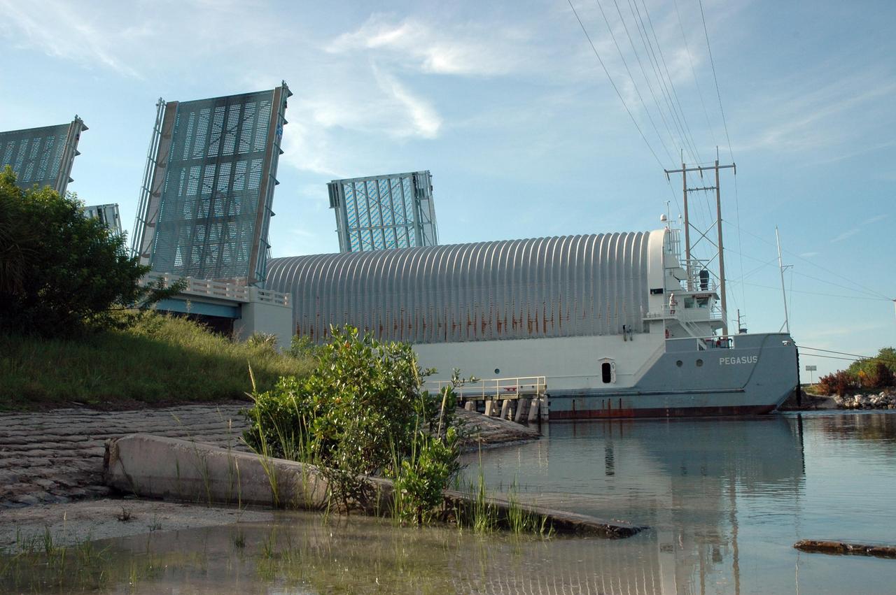 KENNEDY SPACE CENTER, FLA. -- The Pegasus barge passes through the haulover canal on the Banana River with its cargo of external tank No. 125. The barge is being towed to the turn basin in the Launch Complex 39 Area where the external tank will be offloaded and moved to the Vehicle Assembly Building. The external tank will be used on space shuttle Atlantis for mission STS-122 targeted for launch on Dec. 6. Photo credit: NASA/Troy Cryder