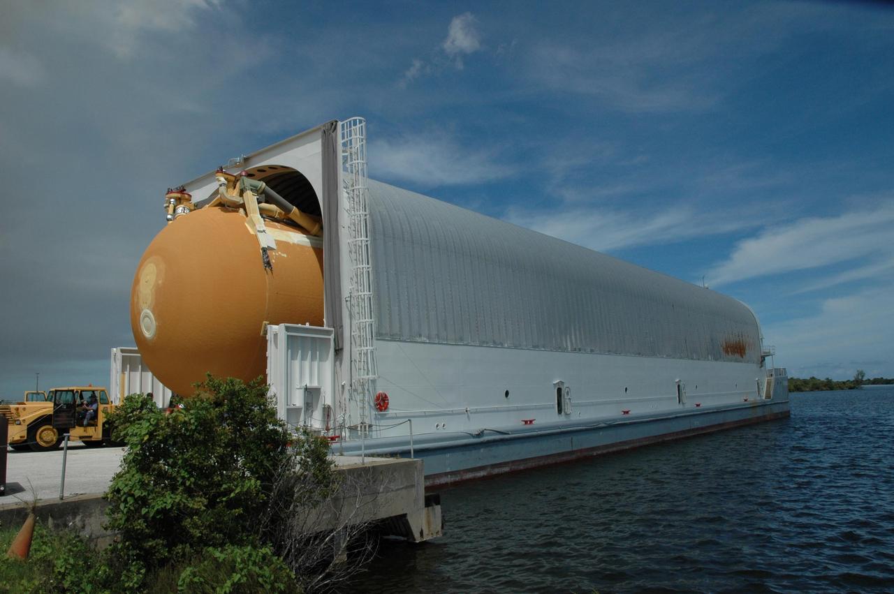 KENNEDY SPACE CENTER, FLA. -- External tank No. 125 is moved out of the Pegasus barge at the Launch Complex 39 Area turn basin. After offloading, the tank will be transported to the Vehicle Assembly Building. The tank arrived at Kennedy on the Pegasus barge from the Michoud Assembly Facility near New Orleans. The external tank will be used on space shuttle Atlantis for mission STS-122 targeted for launch on Dec. 6. Photo credit: NASA/Troy Cryder