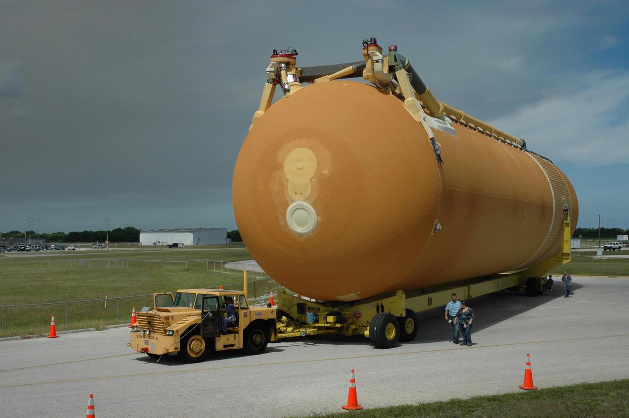 KENNEDY SPACE CENTER, FLA. -- On its transporter, external tank No. 125 maneuvers around a corner on its way to the Vehicle Assembly Building. The tank arrived at the Launch Complex 39 Area turn basin on the Pegasus barge from the Michoud Assembly Facility near New Orleans. The external tank will be used on space shuttle Atlantis for mission STS-122 targeted for launch on Dec. 6. Photo credit: NASA/Troy Cryder
