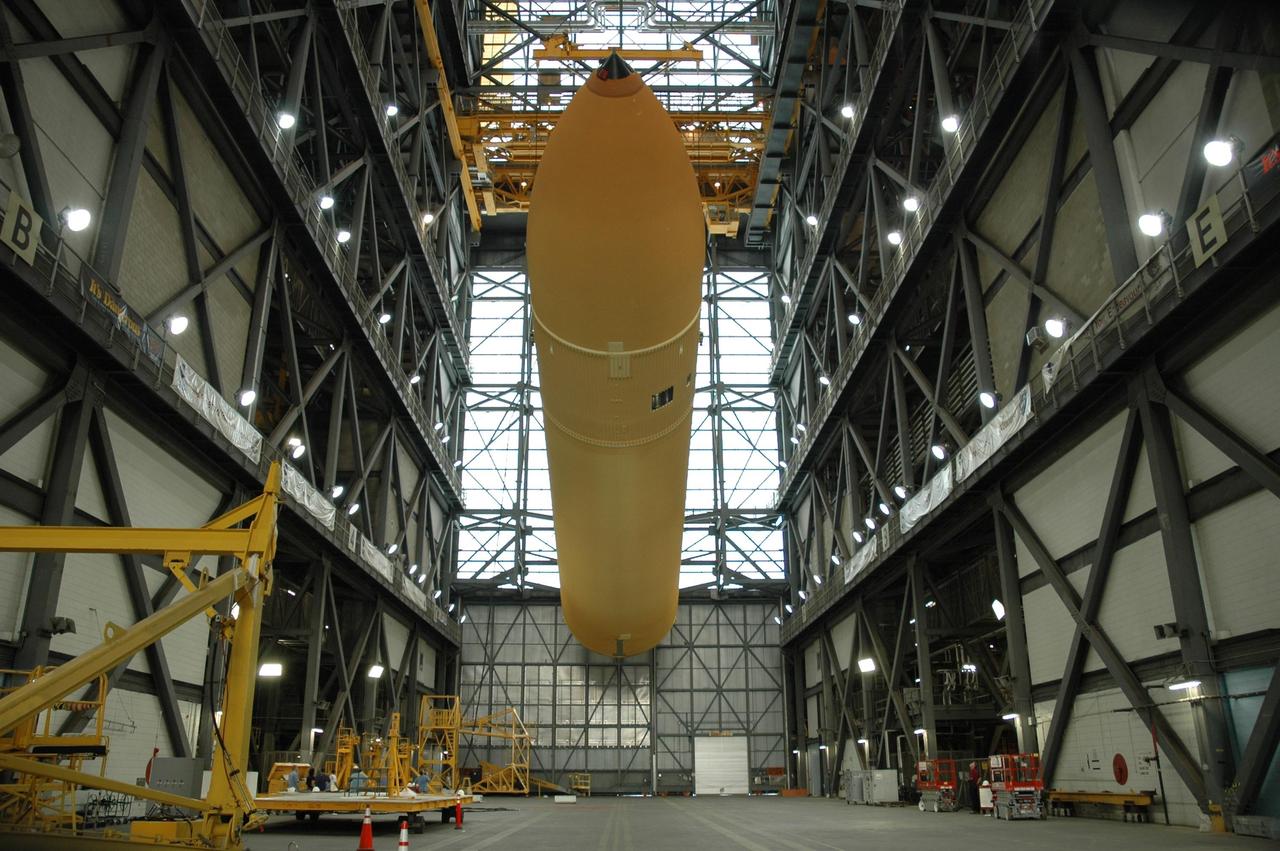 KENNEDY SPACE CENTER, FLA. -- In the transfer aisle of the Vehicle Assembly Building, external tank No. 125 is suspended above the floor as it is being raised to a vertical position. It will then be lifted into a checkout cell in high bay 4 to allow for processing. The tank will be part of the space shuttle stack for mission STS-122 targeted to launch Dec. 6. Photo credit: NASA/Troy Cryder