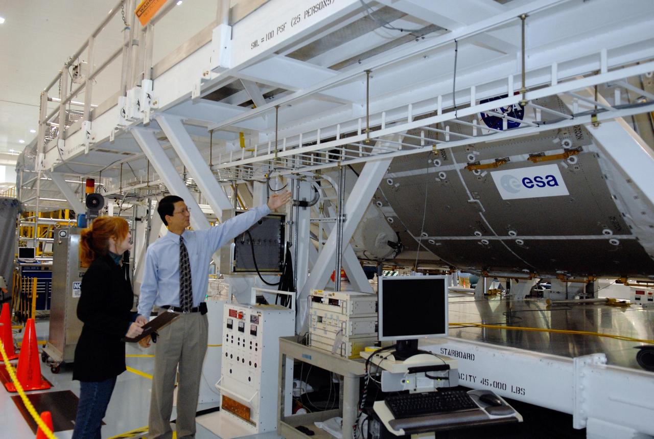 KENNEDY SPACE CENTER, FLA. -- A media event at NASA's Kennedy Space Center highlighted the next piece to be added to the International Space Station, the Italian-built Node-2 module, known as Harmony. At right is Glenn C. Chin, mission manager for International Space Station and Spacecraft Processing, who talked to reporters about processing of the Harmony module. Harmony will launch aboard space shuttle Discovery on mission STS-120, targeted for launch Oct. 23. The module is scheduled to be transferred at the end of the month to Launch Pad 39A, in preparation for its journey to the station. Harmony is approximately 21 feet long and 14 feet in diameter. It will act as an internal connecting port and passageway to additional international science labs and cargo spacecraft. The pressurized module will increase the living and working space inside the station and serve as a work platform outside for the station's robotic arm. Photo credit: NASA/Kim Shiflett