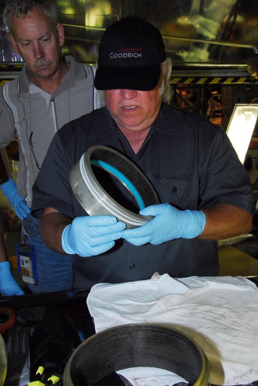 KENNEDY SPACE CENTER, FLA. -- In bay 3 of the Orbiter Processing Facility, B.F. Goodrich technician David Cobb checks the hydraulic seal he replaced in space shuttle Discovery's right main-gear strut.  Engineers determined an observed leak of hydraulic fluid in the main landing gear strut exceeded specification and could not be reduced to an acceptable rate. Thus, the leaky seal and three other seals were replaced.  Prior to discovery of the leak, the vehicle had been scheduled to roll over Sept. 19 from the OPF to the Vehicle Assembly Building. A new rollover date will be set for Discovery, which is targeted for launch on Oct. 23.  Photo credit: NASA/George Shelton