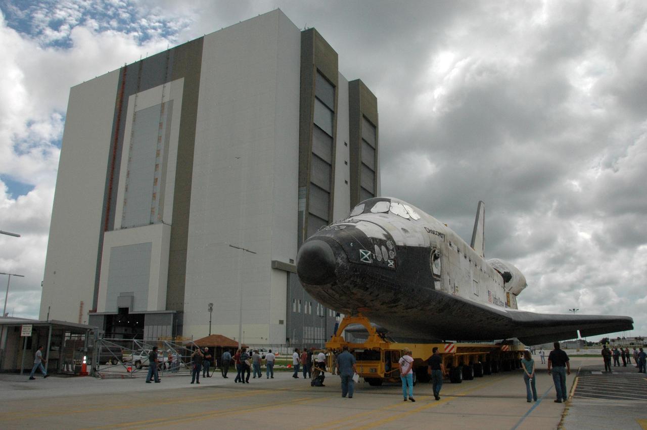 KENNEDY SPACE CENTER, FLA. -- On its transporter, Space shuttle Discovery rolls to the Vehicle Assembly Building, at left. In the VAB, the shuttle will be lifted and mated with the external tank and solid rocket boosters on the mobile launcher platform. Discovery is targeted for launch to the International Space Station for mission STS-120 on Oct. 23. The crew will be delivering and installing the Italian-built U.S. Node 2, named Harmony. The pressurized module will act as an internal connecting port and passageway to additional international science labs and cargo spacecraft. In addition to increasing the living and working space inside the station, it also will serve as a work platform outside for the station's robotic arm. Photo credit: NASA/Charisse Nahser