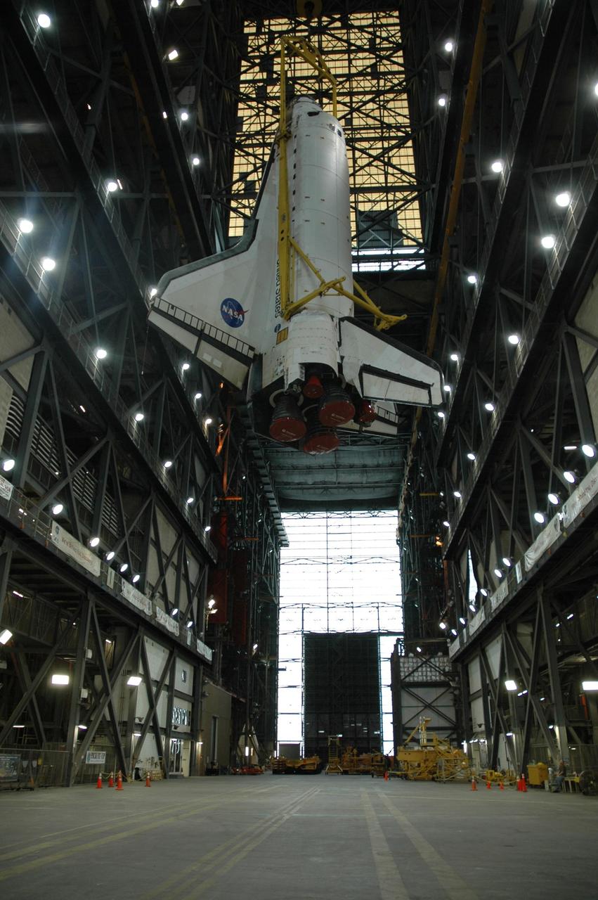 KENNEDY SPACE CENTER, FLA. -- Inside the Vehicle Assembly Building, space shuttle Discovery is lifted into the upper regions for transfer to high bay 1. In the bay, Discovery will be mated with the external tank and solid rocket boosters waiting on the mobile launcher platform. Discovery is targeted for launch to the International Space Station for mission STS-120 on Oct. 23. The crew will be delivering and installing the Italian-built U.S. Node 2, named Harmony. The pressurized module will act as an internal connecting port and passageway to additional international science labs and cargo spacecraft. In addition to increasing the living and working space inside the station, it also will serve as a work platform outside for the station's robotic arm. Photo credit: NASATroy Cryder