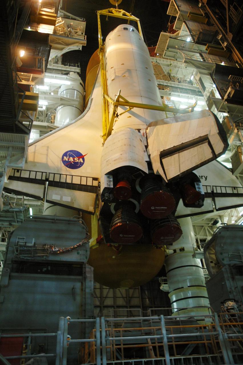 KENNEDY SPACE CENTER, FLA. -- Inside the Vehicle Assembly Building, space shuttle Discovery is lowered next to the external tank and solid rocket boosters already installed on the mobile launcher platform. Discovery is targeted for launch to the International Space Station for mission STS-120 on Oct. 23. The crew will be delivering and installing the Italian-built U.S. Node 2, named Harmony. The pressurized module will act as an internal connecting port and passageway to additional international science labs and cargo spacecraft. In addition to increasing the living and working space inside the station, it also will serve as a work platform outside for the station's robotic arm. Photo credit: NASA/Troy Cryder