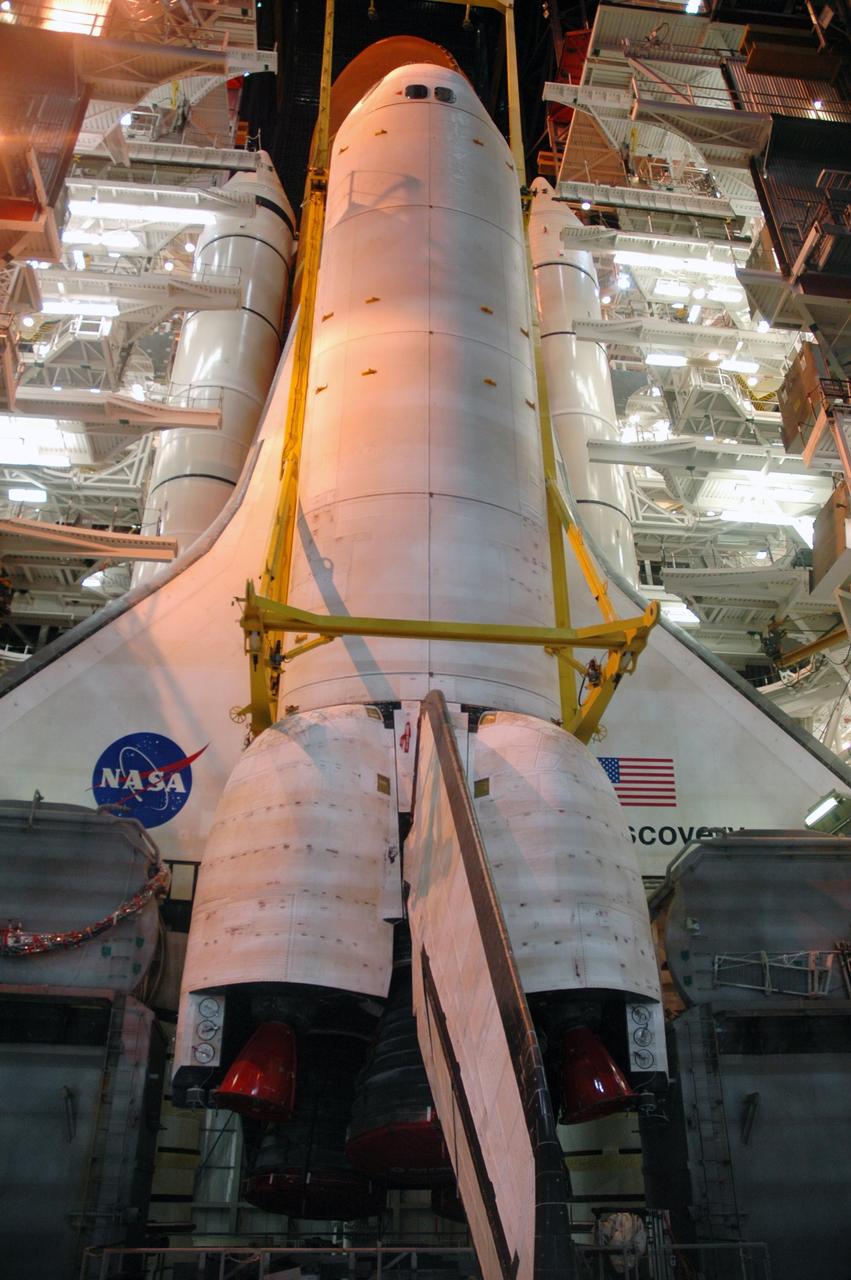 KENNEDY SPACE CENTER, FLA. -- Inside the Vehicle Assembly Building, space shuttle Discovery has been lowered next to the external tank and solid rocket boosters already installed on the mobile launcher platform. Discovery is targeted for launch to the International Space Station for mission STS-120 on Oct. 23. The crew will be delivering and installing the Italian-built U.S. Node 2, named Harmony. The pressurized module will act as an internal connecting port and passageway to additional international science labs and cargo spacecraft. In addition to increasing the living and working space inside the station, it also will serve as a work platform outside for the station's robotic arm. Photo credit: NASA/Troy Cryder