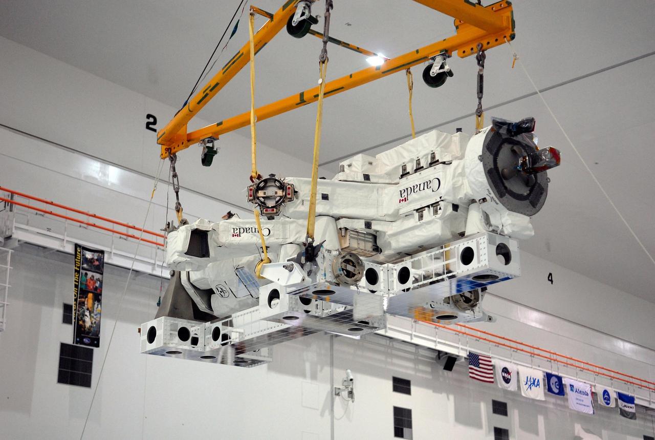 KENNEDY SPACE CENTER, FLA. -- In the Space Station Processing Facility at NASA's Kennedy Space Center, a crane lifts the Special Purpose Dexterous Manipulator, known as Dextre, to position it onto a pallet. Processing of the payload is under way for its mission to the International Space Station. Dextre will work with the mobile base and Canadarm2 on the station to perform critical construction and maintenance tasks. Dextre is part of the payload scheduled on mission STS-123, targeted to launch Feb. 14, 2008. Photo credit: NASA/Kim Shiflett