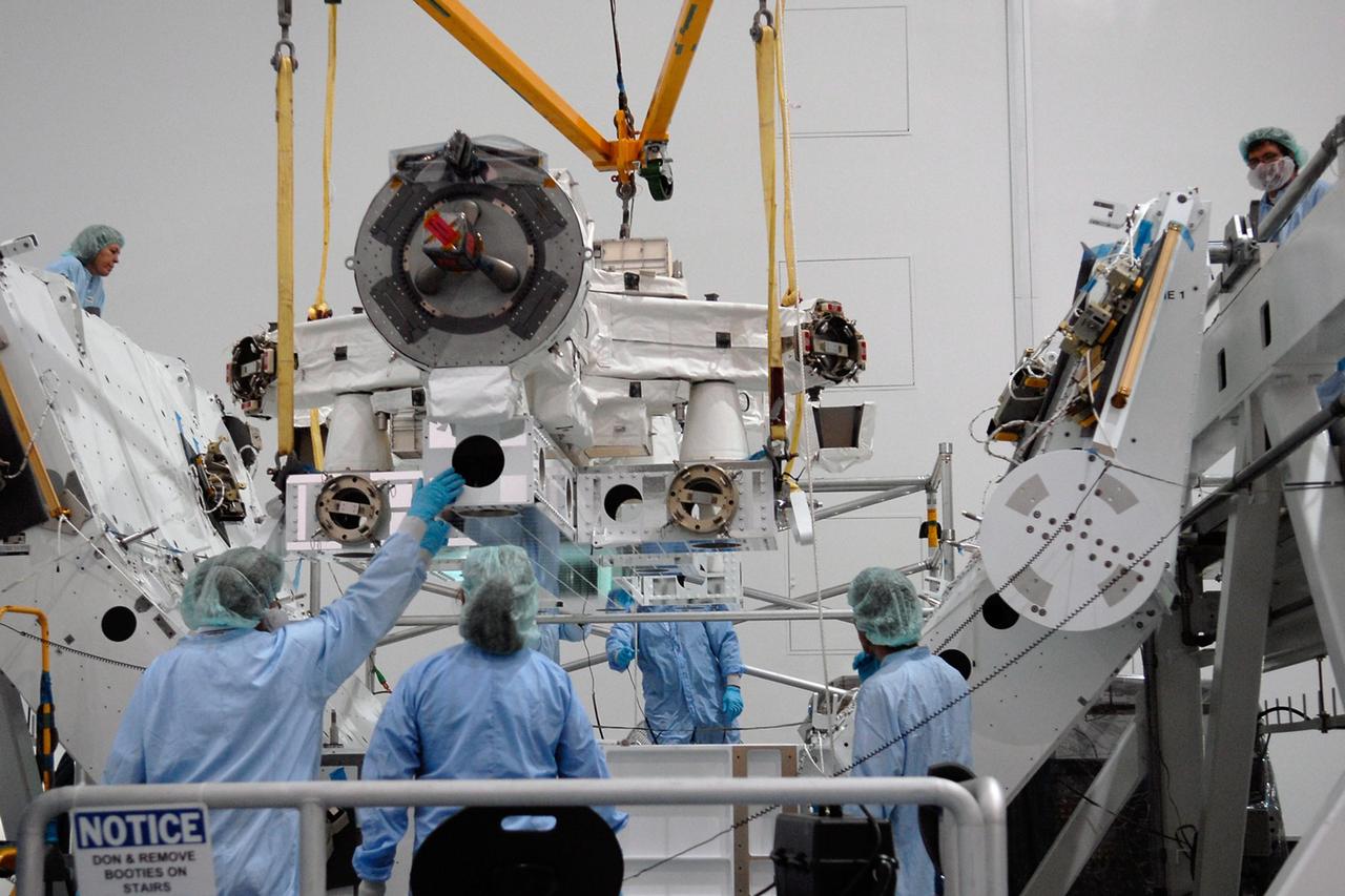 KENNEDY SPACE CENTER, FLA. -- In the Space Station Processing Facility at NASA's Kennedy Space Center, technicians monitor the Special Purpose Dexterous Manipulator, known as Dextre, as a crane moves it into position on a pallet.  Processing of the payload is under way for its mission to the International Space Station. Dextre will work with the mobile base and Canadarm2 on the station to perform critical construction and maintenance tasks. Dextre is part of the payload scheduled on mission STS-123, targeted to launch Feb. 14, 2008.  Photo credit: NASA/Kim Shiflett