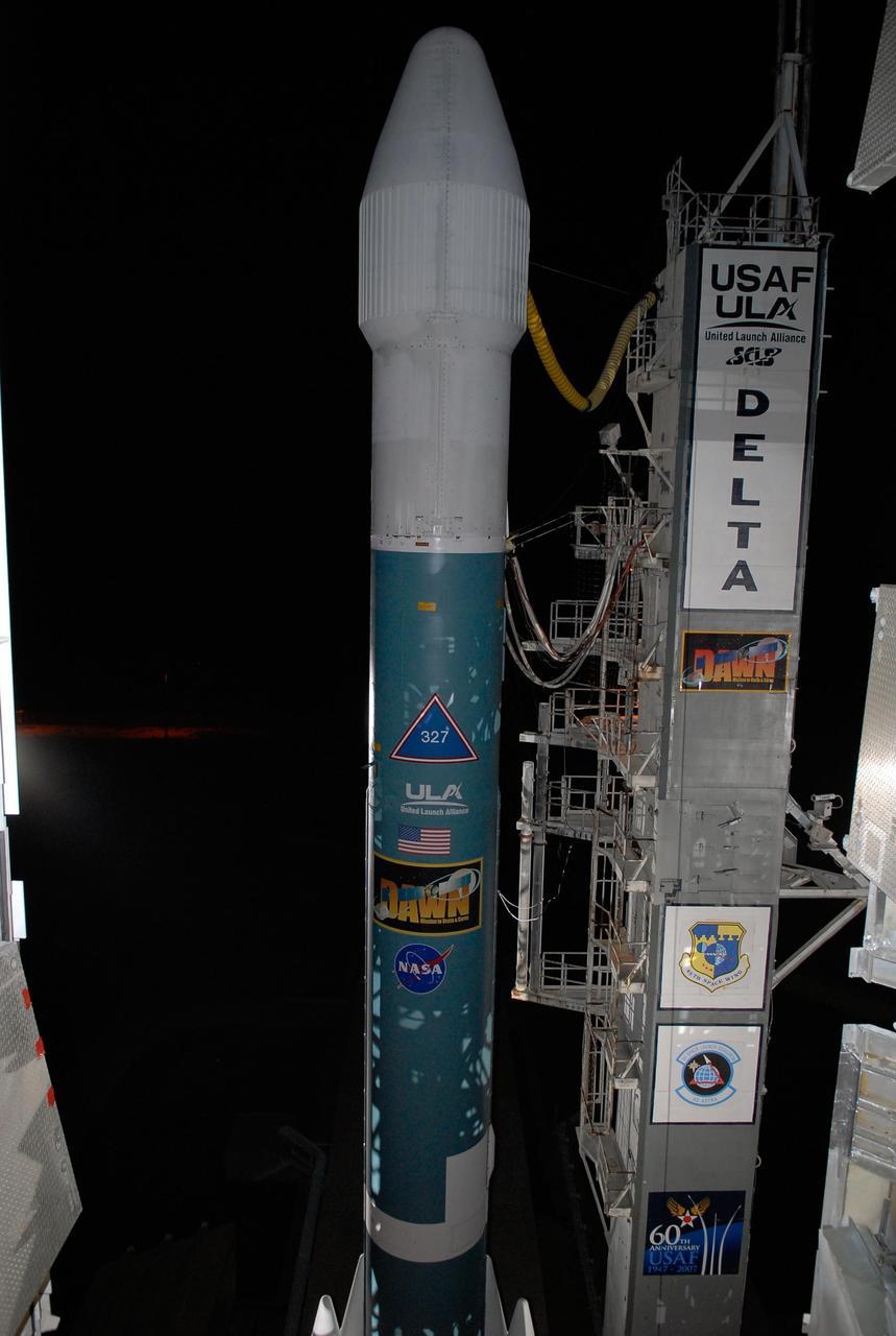 KENNEDY SPACE CENTER, FLA. -- The Delta II rocket stands ready for launch following rollback of the mobile service tower, or gantry, on Launch Pad 17B at Cape Canaveral Air Force Station. Starting with a boost from this higher thrust version of the Delta II rocket, the Dawn spacecraft will study the asteroid Vesta and dwarf planet Ceres, celestial bodies believed to have accreted early in the history of the solar system. To carry out its scientific mission during its nearly decade-long mission, Dawn will carry a visible camera, a visible and infrared mapping spectrometer, and a gamma ray and neutron spectrometer, whose data will be used in combination to characterize these bodies. In addition to the three instruments, radiometric and optical navigation data will provide data relating to the gravity field, and thus, bulk properties and internal structure of the two bodies. Data returned from the Dawn spacecraft could provide opportunities for significant breakthroughs in our knowledge of how the solar system formed. Launch is targeted for Sept. 27 during a window that extends from 7:20 to 7:49 a.m. EDT. Photo credit: NASA/Kim Shiflett