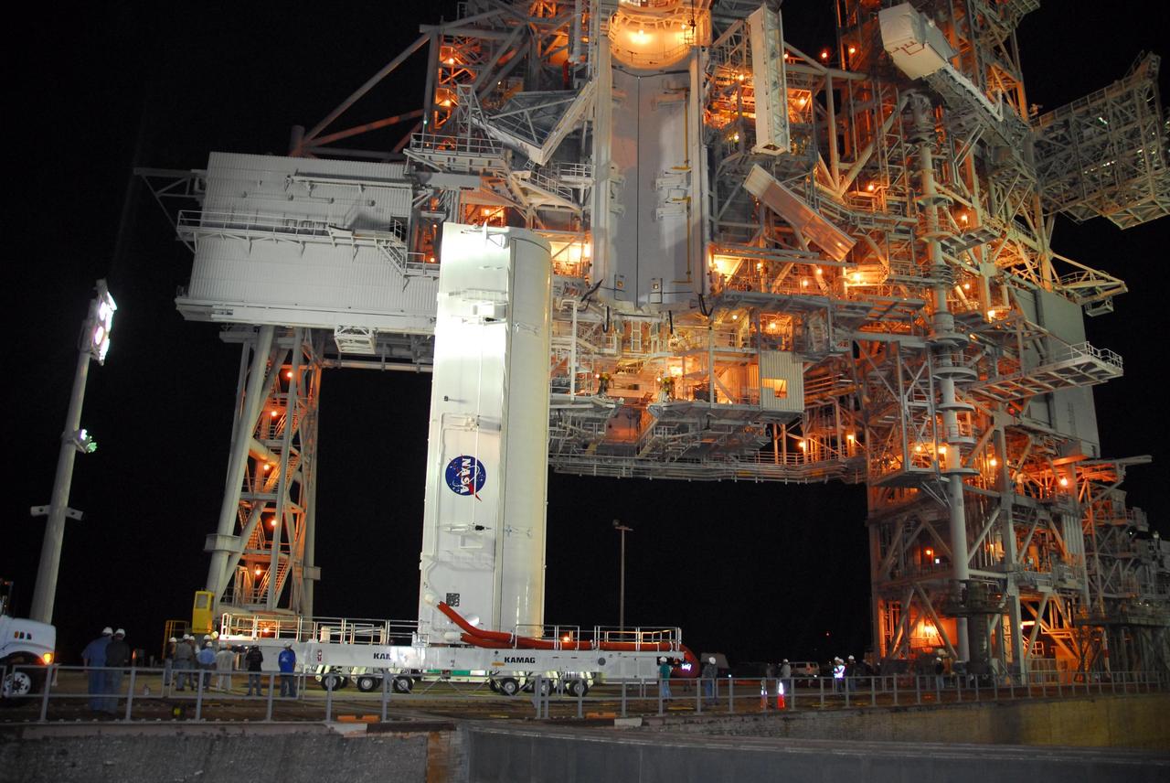 KENNEDY SPACE CENTER, FLA. -- The payload canister containing the Italian-built U.S. Node 2 module, called Harmony, arrives on Launch Pad 39A.  The canister will be lifted to the payload changeout room, seen at the top center, and the module transferred inside.   The payload will be installed in space shuttle Discovery's payload bay after the vehicle rolls out to the pad.  Discovery is targeted for launch to the International Space Station for mission STS-120 on Oct. 23.   The pressurized module will act as an internal connecting port and passageway to additional international science labs and cargo spacecraft.  Photo credit: NASA/George Shelton