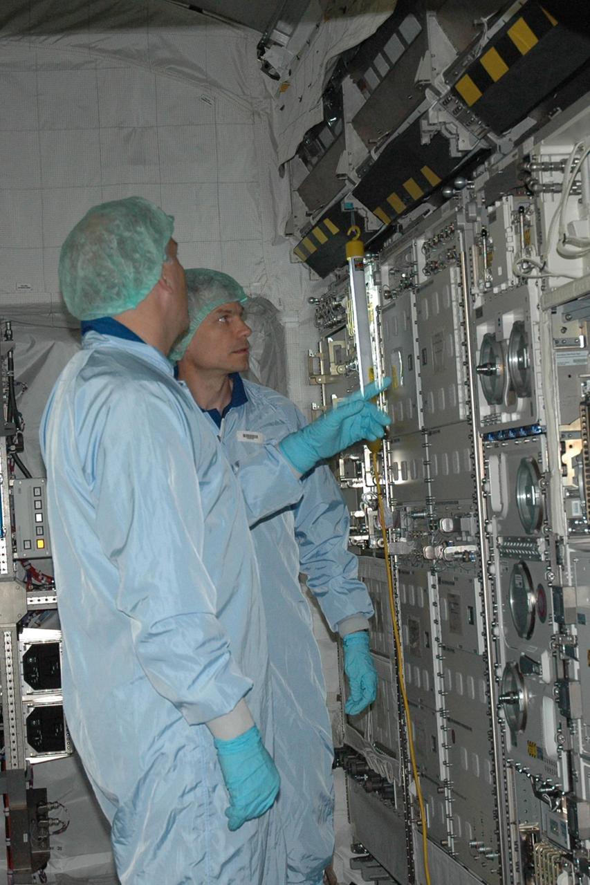 KENNEDY SPACE CENTER, FLA. -- STS-122 Mission Specialist Stanley Love looks at the experiment racks inside the Columbus Research Laboratory in the Space Station Processing Facility. He and other crew members are at Kennedy to take part in a crew equipment interface test, which helps familiarize them with equipment and payloads for the mission. Among the activities standard to a CEIT are harness training, inspection of the thermal protection system and camera operation for planned extravehicular activities, or EVAs. The crew comprises Commander Stephen Frick, Pilot Alan Poindexter, and Mission Specialists Rex Walheim, Stanley Love, Leland Melvin and Hans Schlegel, who represents the European Space Agency. The Columbus Lab is Europe’s largest contribution to the construction of the International Space Station. It will support scientific and technological research in a microgravity environment. Columbus, a program of ESA, is a multifunctional, pressurized laboratory that will be permanently attached to Node 2 of the space station to carry out experiments in materials science, fluid physics and biosciences, as well as to perform a number of technological applications. STS-122 is targeted for launch in December. Photo credit: NASA/Jim Grossmann