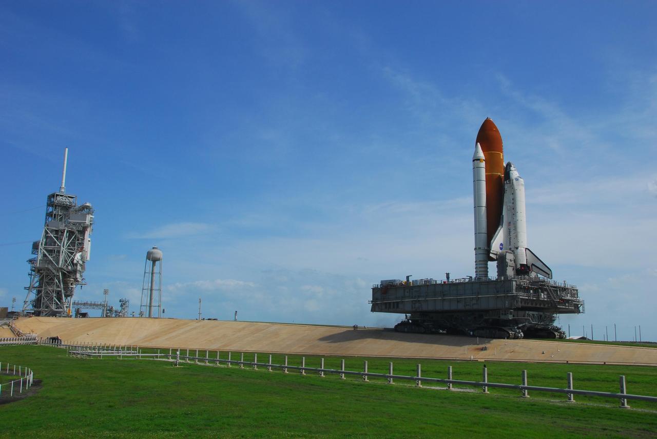 KENNEDY SPACE CENTER, FLA. -- Space Shuttle Discovery, atop a mobile launch platform, climbs the five percent grad to the top of the hardstand at Launch Pad 39A. Discovery arrived at its seaside launch pad around noon and was hard down at 1:15 p.m.  First motion out of the Vehicle Assembly Building was at 6:47 a.m. EDT.  Rollout is a milestone for Discovery's launch to the International Space Station on mission STS-120, targeted for Oct. 23. The crew will be delivering and installing the Italian-built U.S. Node 2, named Harmony. The pressurized module will act as an internal connecting port and passageway to additional international science labs and cargo spacecraft. In addition to increasing the living and working space inside the station, it also will serve as a work platform outside for the station's robotic arm.   Photo credit: NASA/George Shelton
