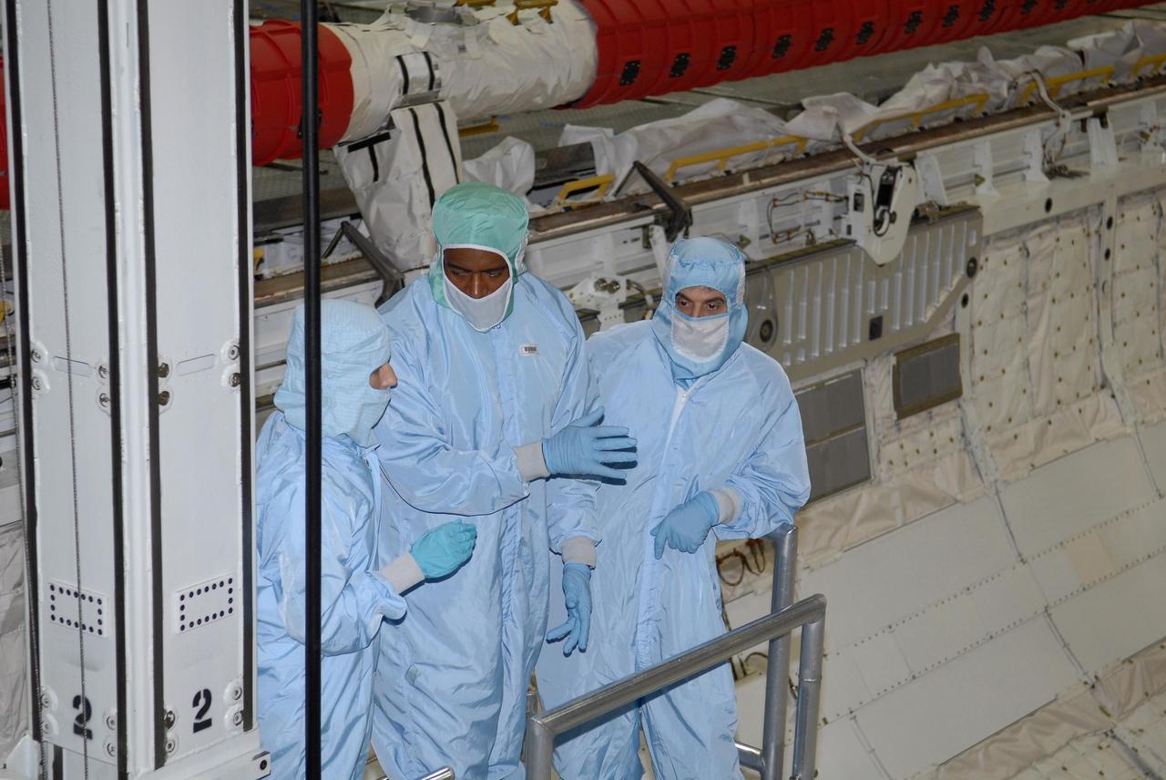 KENNEDY SPACE CENTER, FLA. -- STS-122 crew members take a ride inside space shuttle Atlantis' payload bay to examine components installed there. Seen here are Mission Specialists Leland Melvin (center) and Rex Walheim (right). The crew is at Kennedy Space Center to take part in a crew equipment interface test, which includes equipment familiarization. The mission will carry and install the Columbus Lab, a multifunctional, pressurized laboratory that will be permanently attached to Node 2 of the space station to carry out experiments in materials science, fluid physics and biosciences, as well as to perform a number of technological applications. It is Europe’s largest contribution to the construction of the International Space Station and will support scientific and technological research in a microgravity environment. STS-122 is targeted for launch in December. Photo credit: NASA/Kim Shiflett