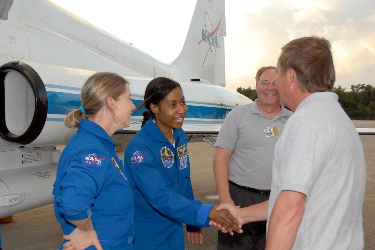 KENNEDY SPACE CENTER, FLA. --  The crew members of mission STS-120 arrive at NASA's Kennedy Space Center Shuttle Landing Facility aboard T-38 jet aircraft to take part in terminal countdown demonstration test activities. Shuttle Launch Director Michael Leinbach shakes hands with Mission Specialist Stephanie Wilson, who will be making her second shuttle flight, as Commander Pam Melroy, at left, looks on. The terminal countdown demonstration test provides astronauts and ground crews an opportunity to participate in various simulated countdown activities, including equipment familiarization and emergency training. The STS-120 mission will deliver the U.S. Node 2 module, named Harmony, aboard space shuttle Discovery to the International Space Station.  Launch of Discovery on mission STS-120 is targeted for Oct. 23 at 11:38 a.m. EDT on a 14-day mission to the International Space Station.  Photo credit: NASA/Kim Shiflett