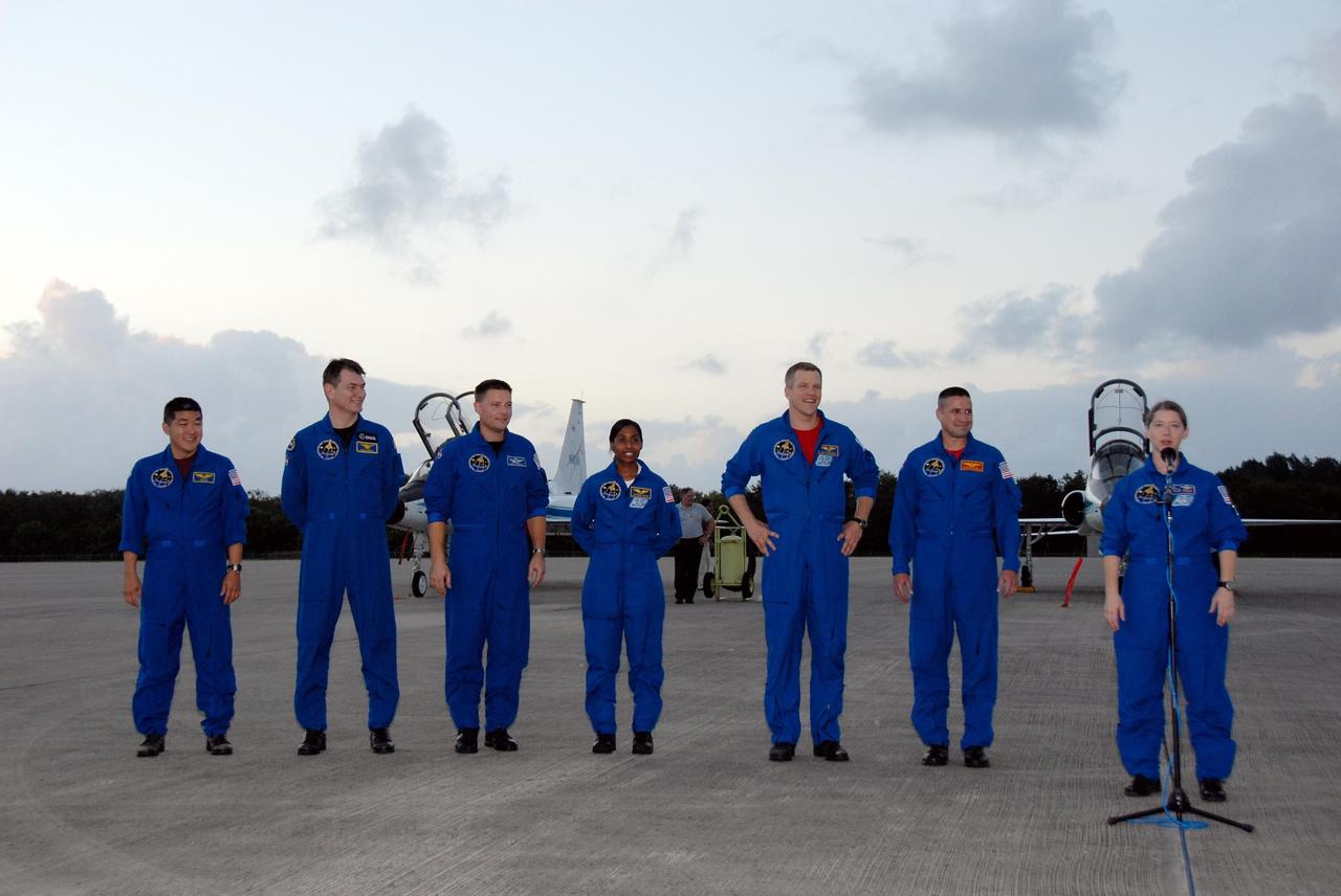 KENNEDY SPACE CENTER, FLA. -- The crew members of mission STS-120 speak to the media following their arrival at NASA's Kennedy Space Center Shuttle Landing Facility aboard T-38 jet aircraft to take part in terminal countdown demonstration test activities. From left are Mission Specialists Daniel Tani, Paolo Nespoli, Doug Wheelock, Stephanie Wilson, Scott Parazynski; Pilot George Zamka and Commander Pam Melroy. The terminal countdown demonstration test provides astronauts and ground crews an opportunity to participate in various simulated countdown activities, including equipment familiarization and emergency training. The STS-120 mission will deliver the U.S. Node 2 module, named Harmony, aboard space shuttle Discovery to the International Space Station. Launch of Discovery on mission STS-120 is targeted for Oct. 23 at 11:38 a.m. EDT on a 14-day mission to the International Space Station. Photo credit: NASA/Kim Shiflett