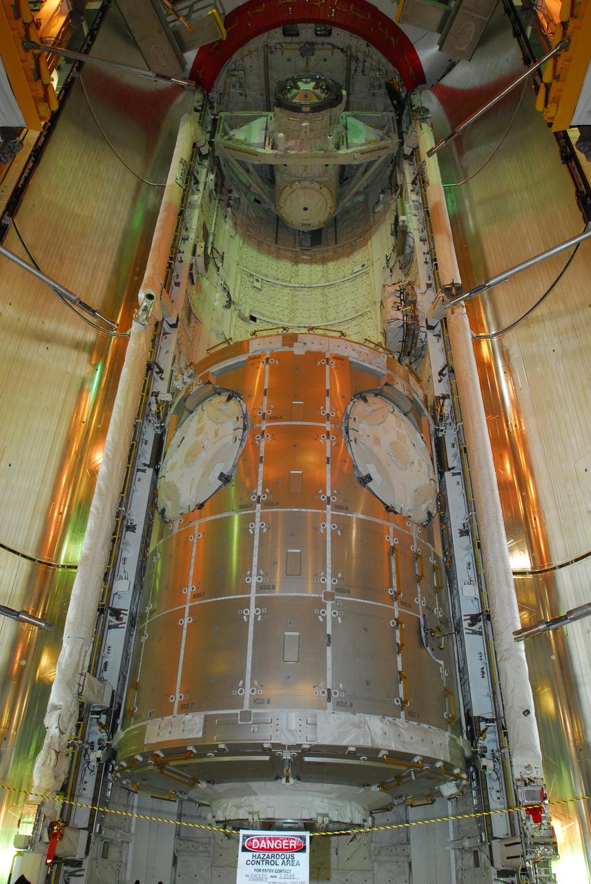 KENNEDY SPACE CENTER, FLA. -- From the payload changeout room on Launch Pad 39A, the payloads for mission STS-120 have been transferred into space shuttle Discovery's payload bay.  Seen at the lower end is the Italian-built U.S. Node 2 module, named Harmony.  At the top is the orbital docking system. The red ring at top comprises rain gutters to prevent leaks into the bay from rain while the shuttle is on the pad.   Mission STS-120 will bring the Harmony module that will provide attachment points for European and Japanese laboratory modules to the International Space Station.  Launch of Discovery is targeted for Oct. 23.  Photo credit: NASA/George Shelton