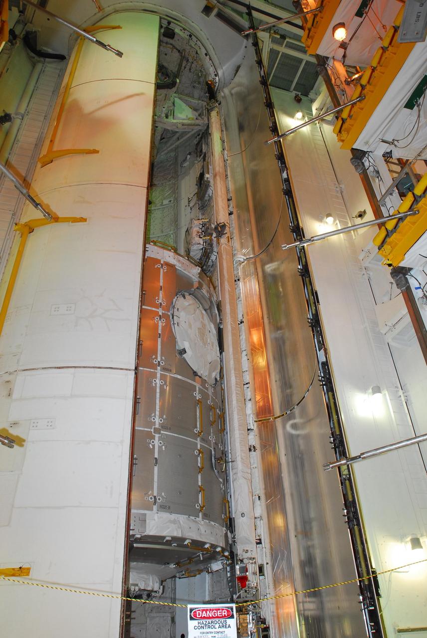 KENNEDY SPACE CENTER, FLA. --   On Launch Pad 39A, one of space shuttle Discovery's payload bay doors is closed.  Inside can still be seen the payloads, the U.S. Node 2, named Harmony (lower), and orbital docking system (upper).  Mission STS-120 will bring the Harmony module that will provide attachment points for European and Japanese laboratory modules to the International Space Station.  Launch of Discovery is targeted for Oct. 23.  Photo credit: NASA/George Shelton
