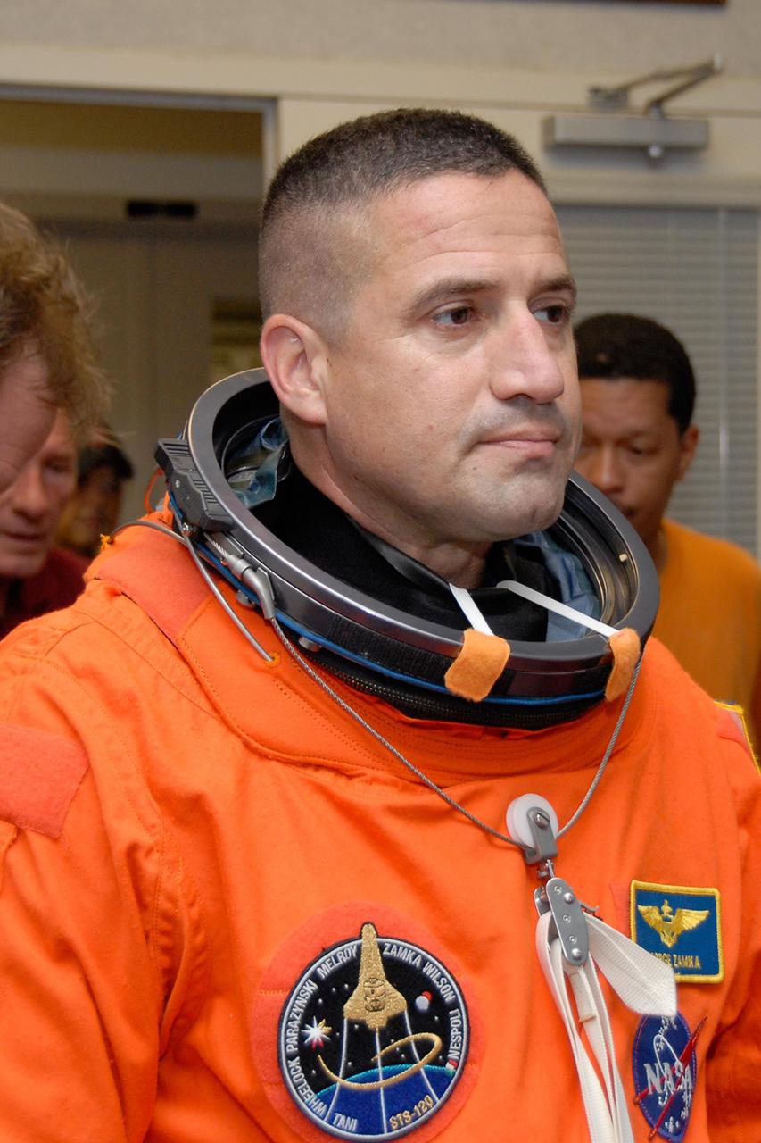 KENNEDY SPACE CENTER, FLA. --  STS-120 Pilot George Zamka dons his launch and entry suit.  He will join Commander Pamela Melroy in practicing landing on NASA's Shuttle Landing Facility runway in the shuttle training aircraft, or STA.   A modified Grumman American Aviation-built Gulf Stream II jet, the STA simulates an orbiter's cockpit, motion and visual cues and handling qualities. In flight, the STA duplicates the orbiter's atmospheric descent trajectory from approximately 35,000 feet altitude to landing on a runway.  Melroy and other crew members are at Kennedy Space Center to take part in the terminal countdown demonstration test, which also includes a simulated launch countdown. Mission STS-120 is targeted for Oct. 23.  Photo credit: NASA/Kim Shiflett