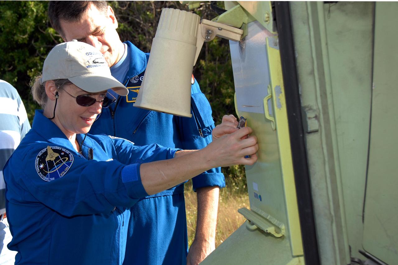 KENNEDY SPACE CENTER, FLA. --  STS-120 Pamela Melroy is ready for training on the M-113 armored personnel carrier, part of emergency egress training.  Behind her Mission Specialist Paolo Nespoli looks on.  Nespoli is with the European Space Agency.  The training is part of terminal countdown demonstration test, or TCDT, activities the crew is undertaking at NASA's Kennedy Space Center. The TCDT also includes equipment familiarization and a simulated launch countdown. Mission STS-120, which will carry the Italian-built U.S. Node 2 to the International Space Station, is targeted for launch on Oct. 23.  Photo credit: NASA/Kim Shiflett