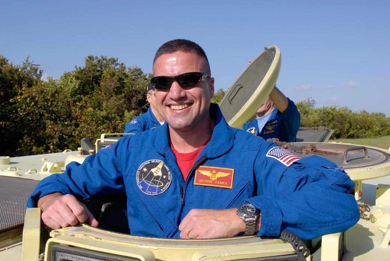 KENNEDY SPACE CENTER, FLA. --  STS-120 Pilot George Zamka gets ready in the driver's seat for driving practice in the M-113 armored personnel carrier. The M-113 is part of emergency exit procedures from Launch Pad 39A.   Behind Zamka, half hidden, is Mission Specialist Paolo Nespoli, who represents the European Space Agency. The training is part of terminal countdown demonstration test, or TCDT, activities the crew is undertaking at NASA's Kennedy Space Center. The TCDT also includes equipment familiarization and a simulated launch countdown. Mission STS-120, which will carry the Italian-built U.S. Node 2 to the International Space Station, is targeted for launch on Oct. 23.  Photo credit: NASA/Kim Shiflett