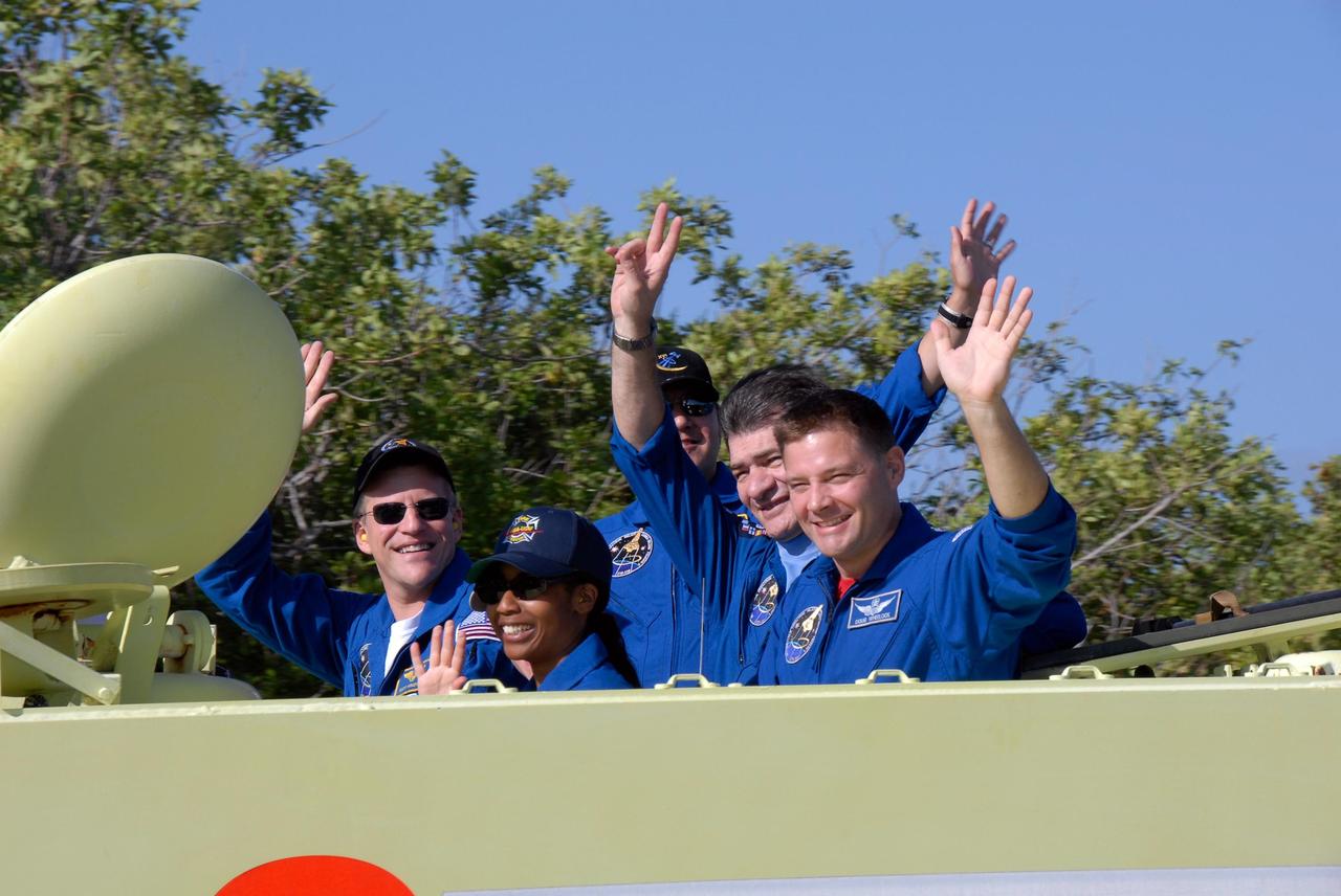 KENNEDY SPACE CENTER, FLA. --  STS-120 crew members signal their pleasure in participating in M-113 driving practice, part of emergency exit procedures from Launch Pad 39A.  Seen here on the M-113 are Mission Specialists Scott Parazynski, Stephanie Wilson, Daniel Tani, Paolo Nespoli and Doug Wheelock.  Nespoli represents the European Space Agency.  The training is part of terminal countdown demonstration test, or TCDT, activities the crew is undertaking at NASA's Kennedy Space Center. The TCDT also includes equipment familiarization and a simulated launch countdown. Mission STS-120, which will carry the Italian-built U.S. Node 2 to the International Space Station, is targeted for launch on Oct. 23.  Photo credit: NASA/Kim Shiflett