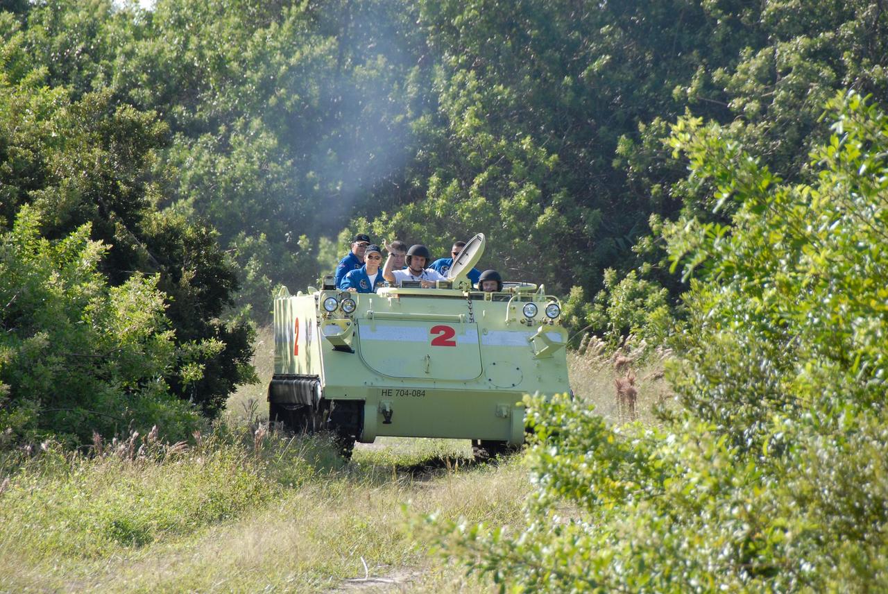 KENNEDY SPACE CENTER, FLA. --  An M-113 armored personnel carrier pushes through the underbrush during driving practice by the STS-120 crew.  In the driver's seat, at right, is Mission Specialist Doug Wheelock.  In the center is the trainer.   Other crew members in the rear are (left to right) Mission Specialists Daniel Tani, Scott Parazynski and Paolo Nespoli and Pilot George Zamka. Nespoli represents the European Space Agency.  The training is part of terminal countdown demonstration test, or TCDT, activities the crew is undertaking at NASA's Kennedy Space Center. The TCDT also includes equipment familiarization and a simulated launch countdown. Mission STS-120, which will carry the Italian-built U.S. Node 2 to the International Space Station, is targeted for launch on Oct. 23.  Photo credit: NASA/Kim Shiflett