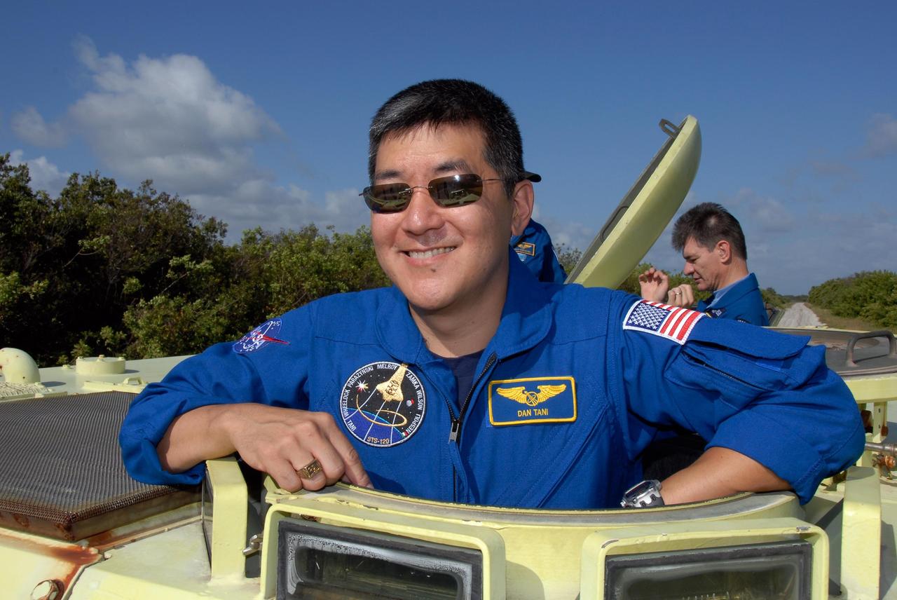 KENNEDY SPACE CENTER, FLA. --  STS-120 Mission Specialist Daniel Tani is ready for his turn at driving the M-113 armored personnel carrier. The M-113 is part of emergency exit procedures from Launch Pad 39A.  Behind him, at right, is Mission Specialist Paolo Nespoli, who represents the European Space Agency. The training is part of terminal countdown demonstration test, or TCDT, activities the crew is undertaking at NASA's Kennedy Space Center. The TCDT also includes equipment familiarization and a simulated launch countdown. Mission STS-120, which will carry the Italian-built U.S. Node 2 to the International Space Station, is targeted for launch on Oct. 23.  Photo credit: NASA/Kim Shiflett