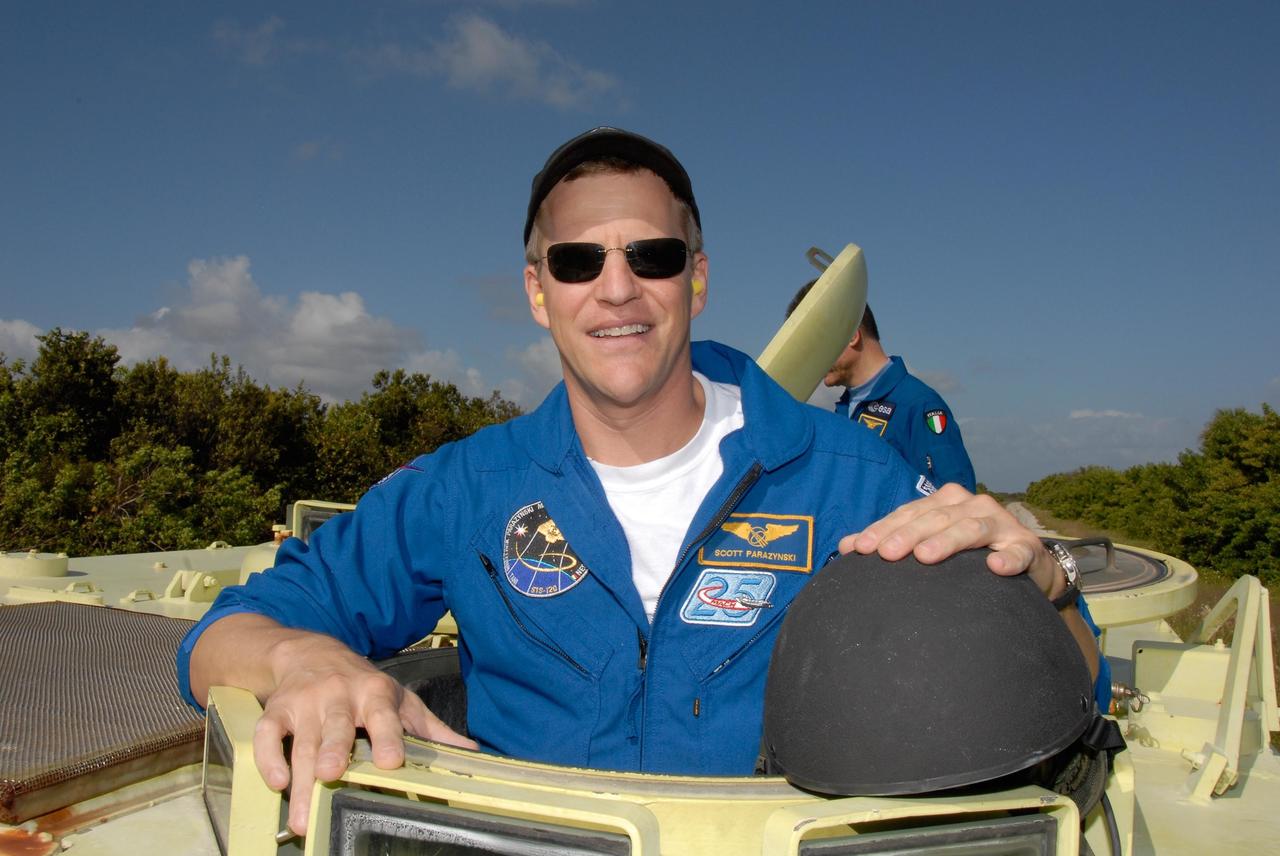 KENNEDY SPACE CENTER, FLA. --  STS-120 Mission Specialist Scott Parazynski is ready for his turn at driving the M-113 armored personnel carrier. The M-113 is part of emergency exit procedures from Launch Pad 39A.   Behind Parazynski is Mission Specialist Paolo Nespoli, who represents the European Space Agency.  The training is part of terminal countdown demonstration test, or TCDT, activities the crew is undertaking at NASA's Kennedy Space Center. The TCDT also includes equipment familiarization and a simulated launch countdown. Mission STS-120, which will carry the Italian-built U.S. Node 2 to the International Space Station, is targeted for launch on Oct. 23.  Photo credit: NASA/Kim Shiflett