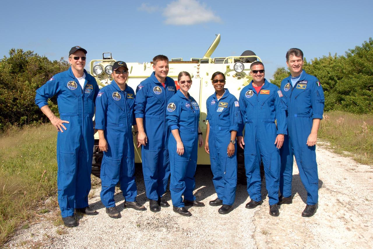 KENNEDY SPACE CENTER, FLA. --  After driving practice on the M-113 armored personnel carrier, the STS-120 crew pauses for a group photo.  From left are Mission Specialists Scott Parazynski, Daniel Tani and Doug Wheelock, Commander Pamela Melroy, Mission Specialist Stephanie Wilson, Pilot George Zamka and Mission Specialist Paolo Nespoli, who represents the European Space Agency. The M-113 is part of emergency exit procedures from Launch Pad 39A.  The training is part of terminal countdown demonstration test, or TCDT, activities the crew is undertaking at NASA's Kennedy Space Center. The TCDT also includes equipment familiarization and a simulated launch countdown. Mission STS-120, which will carry the Italian-built U.S. Node 2 to the International Space Station, is targeted for launch on Oct. 23.  Photo credit: NASA/Kim Shiflett